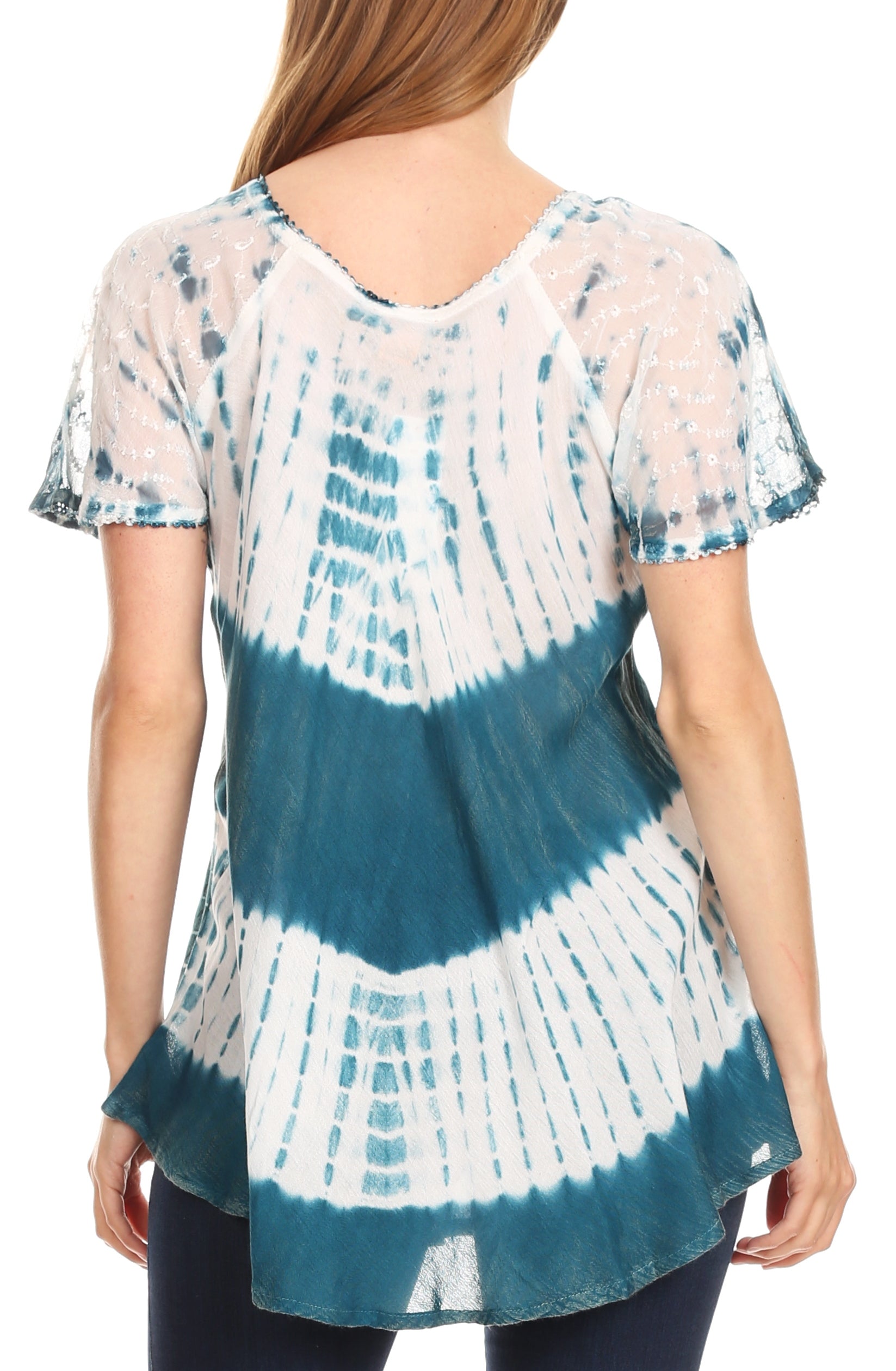 Woman wearing a tie-dye shirt with blue and white patterns on a white background