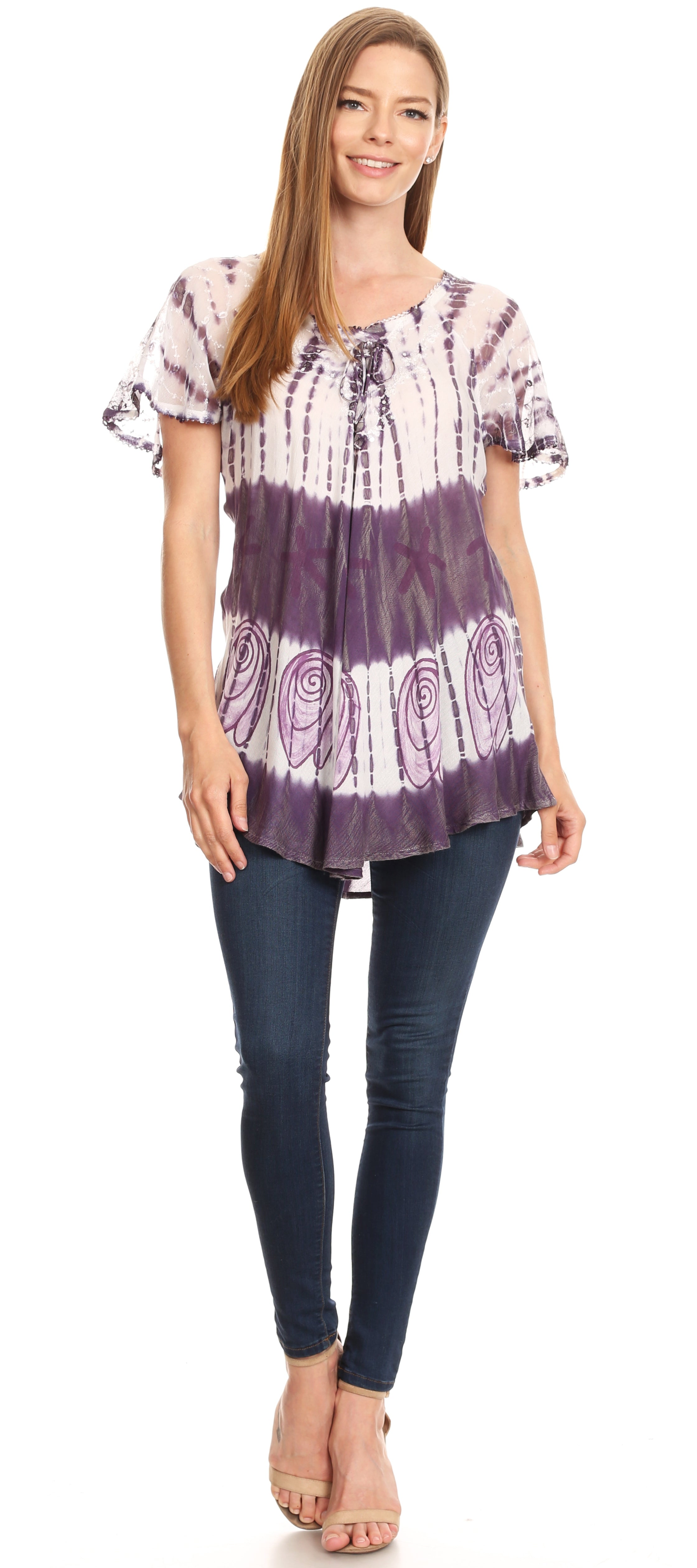 Woman wearing a tie-dye shirt and jeans on a white background