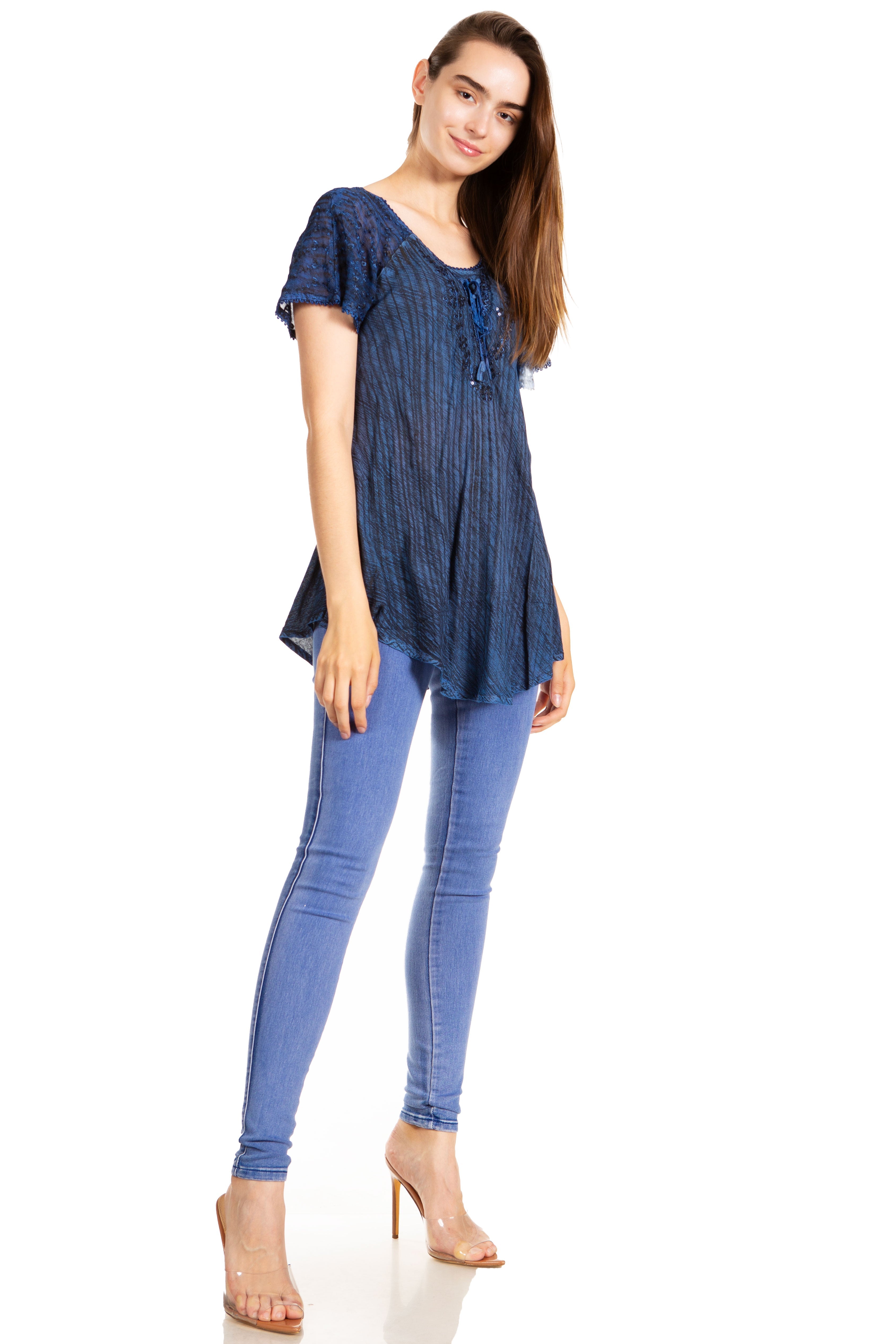 Woman wearing a blue top and jeans on a white background