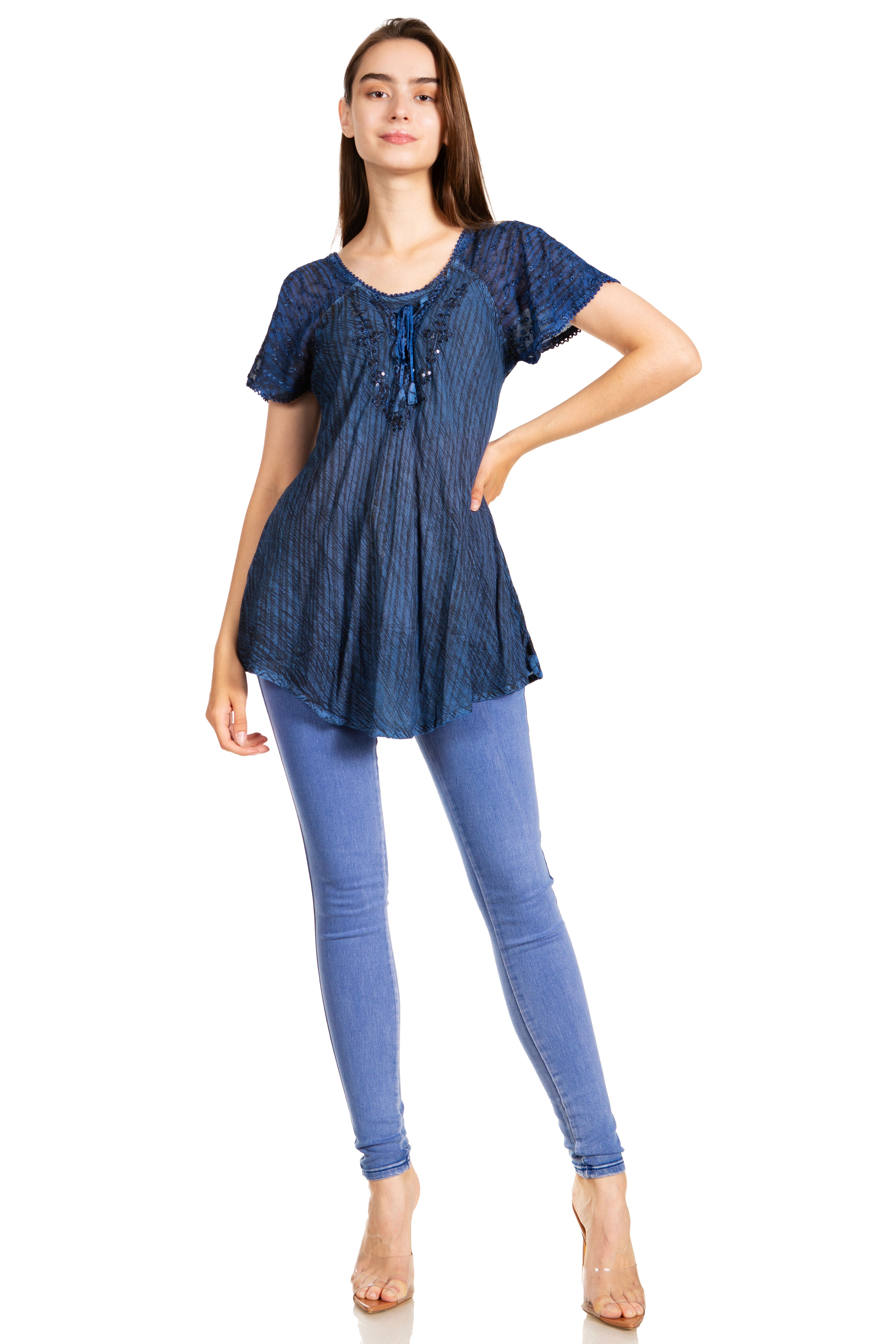 Woman wearing a blue patterned top and jeans on a white background