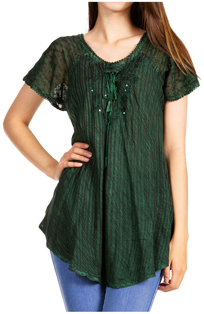 Green lace top worn by a person on a white background