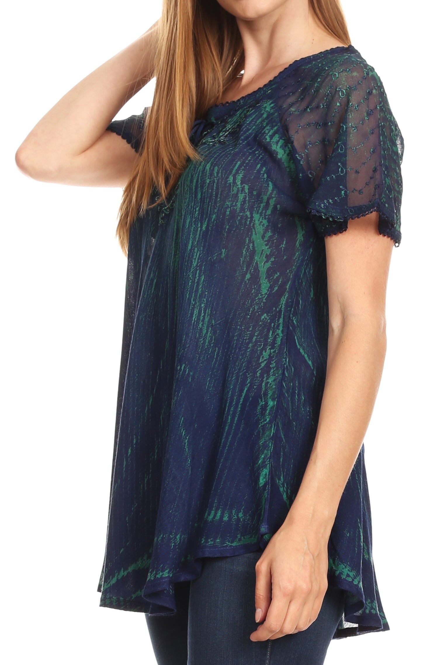 Woman wearing a dark blue and green patterned top on a white background