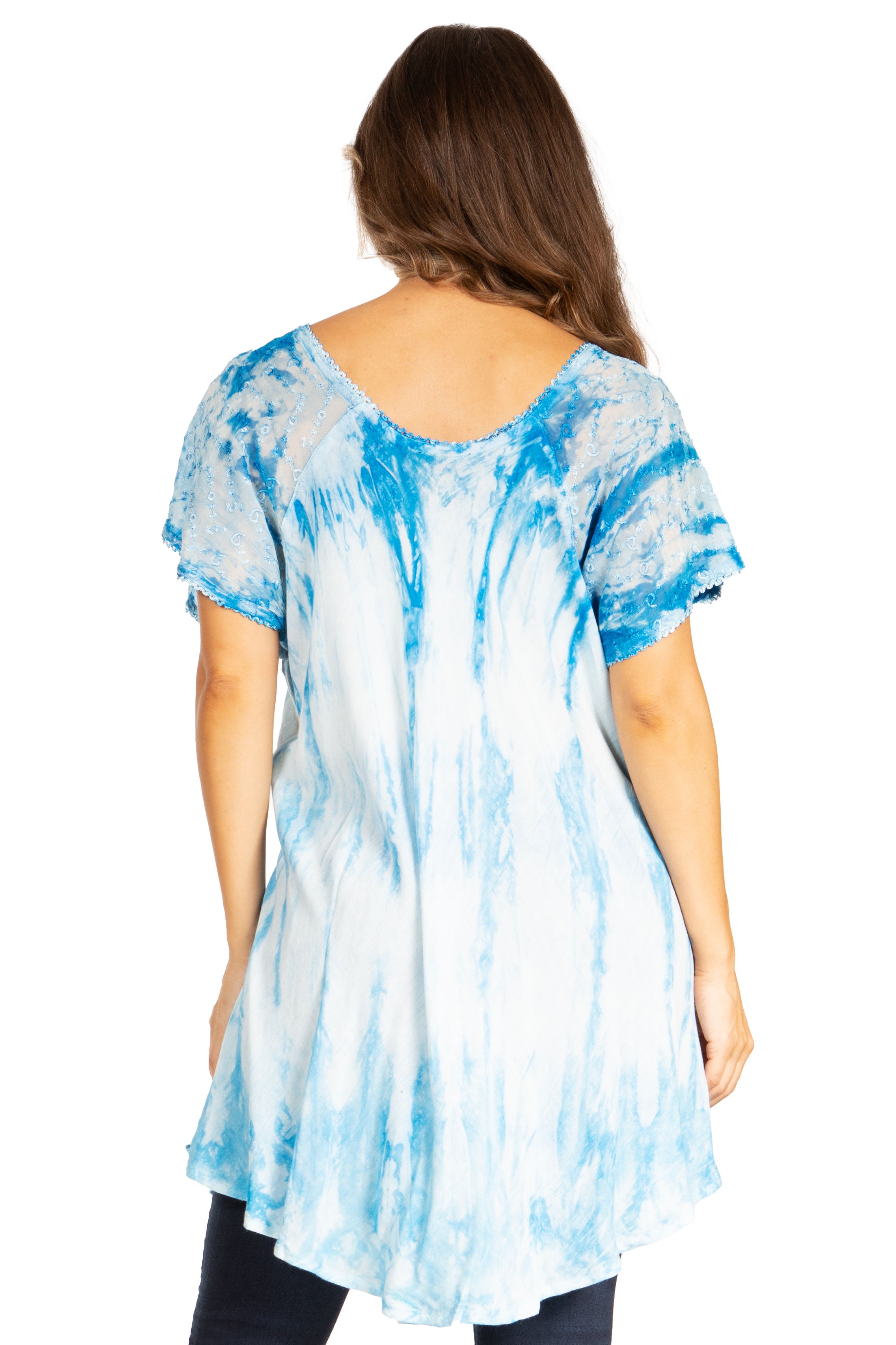 Woman wearing a blue and white tie-dye tunic on a white background
