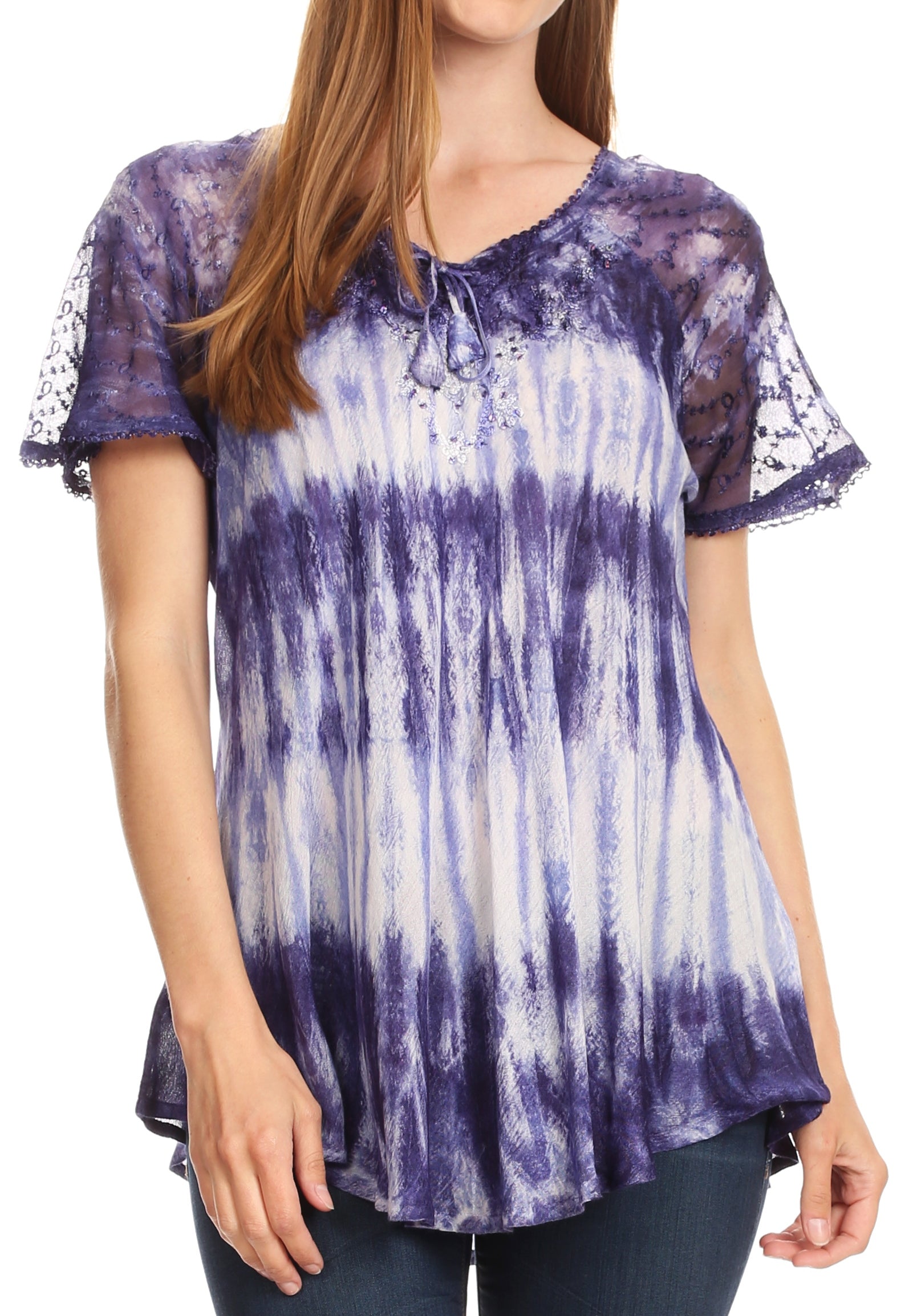 Person wearing a purple and white tie-dye top with sheer sleeves on a white background