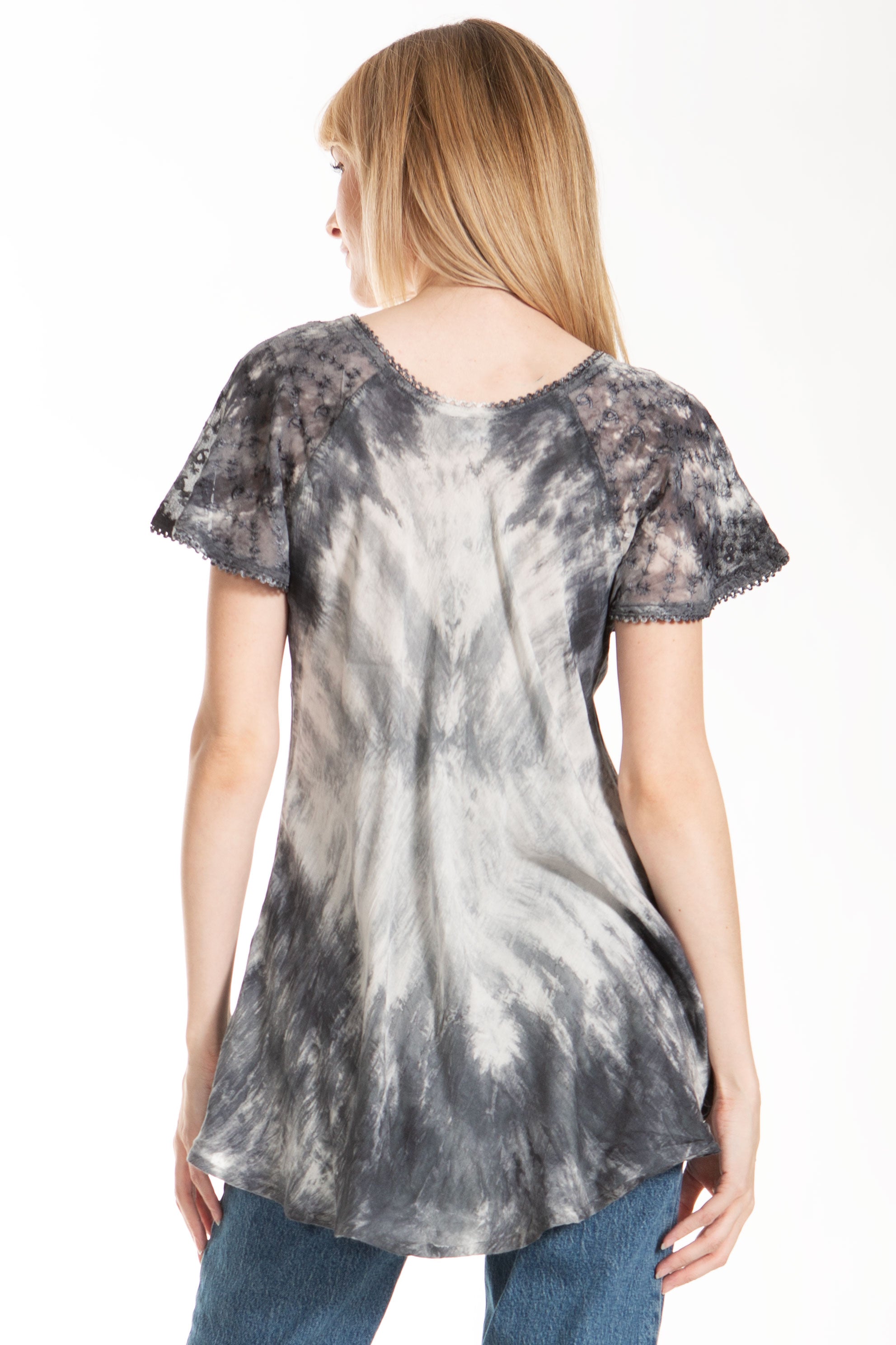 Woman wearing a tie-dye shirt on a white background