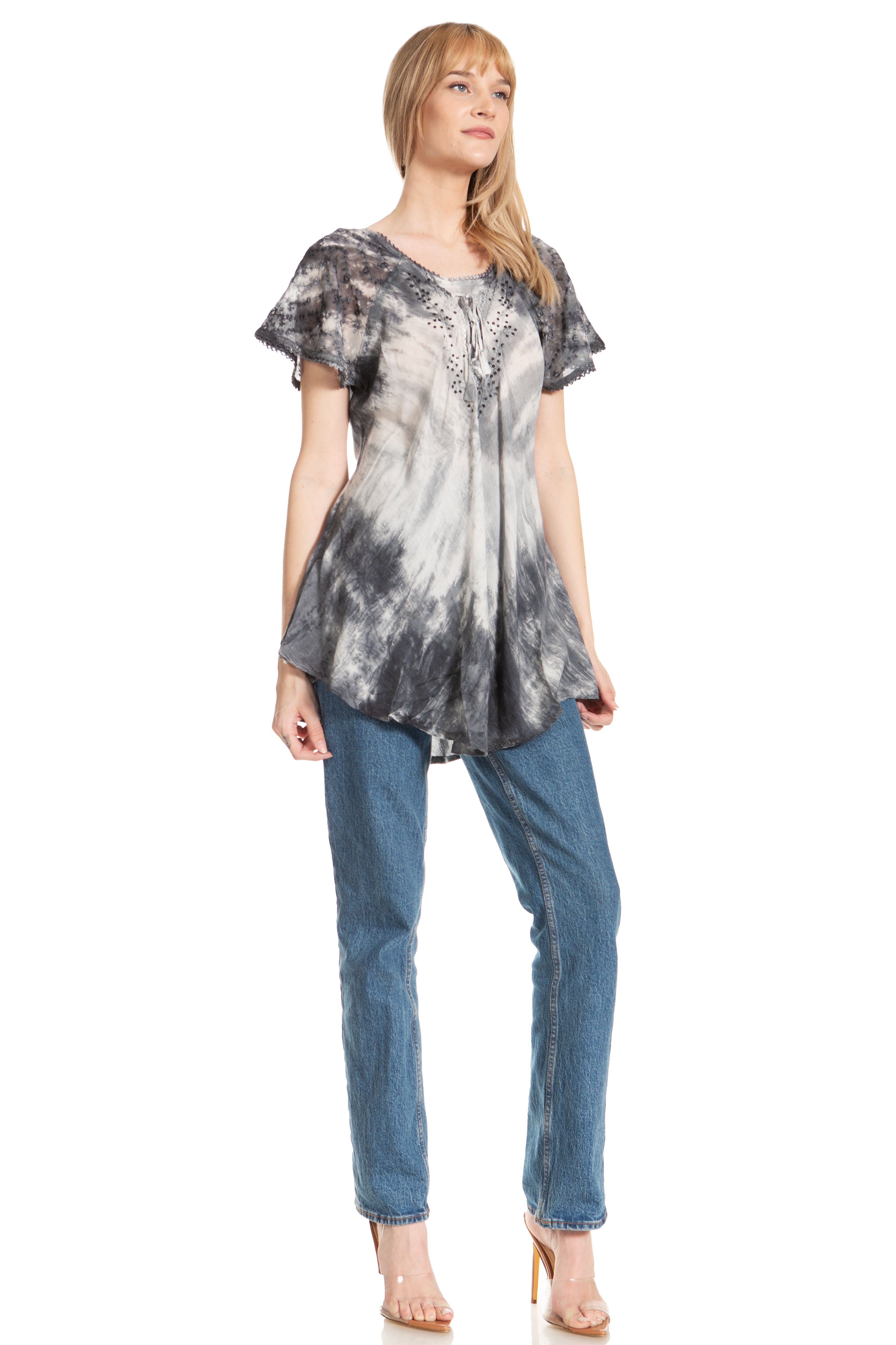 Woman wearing a tie-dye top and jeans on a white background