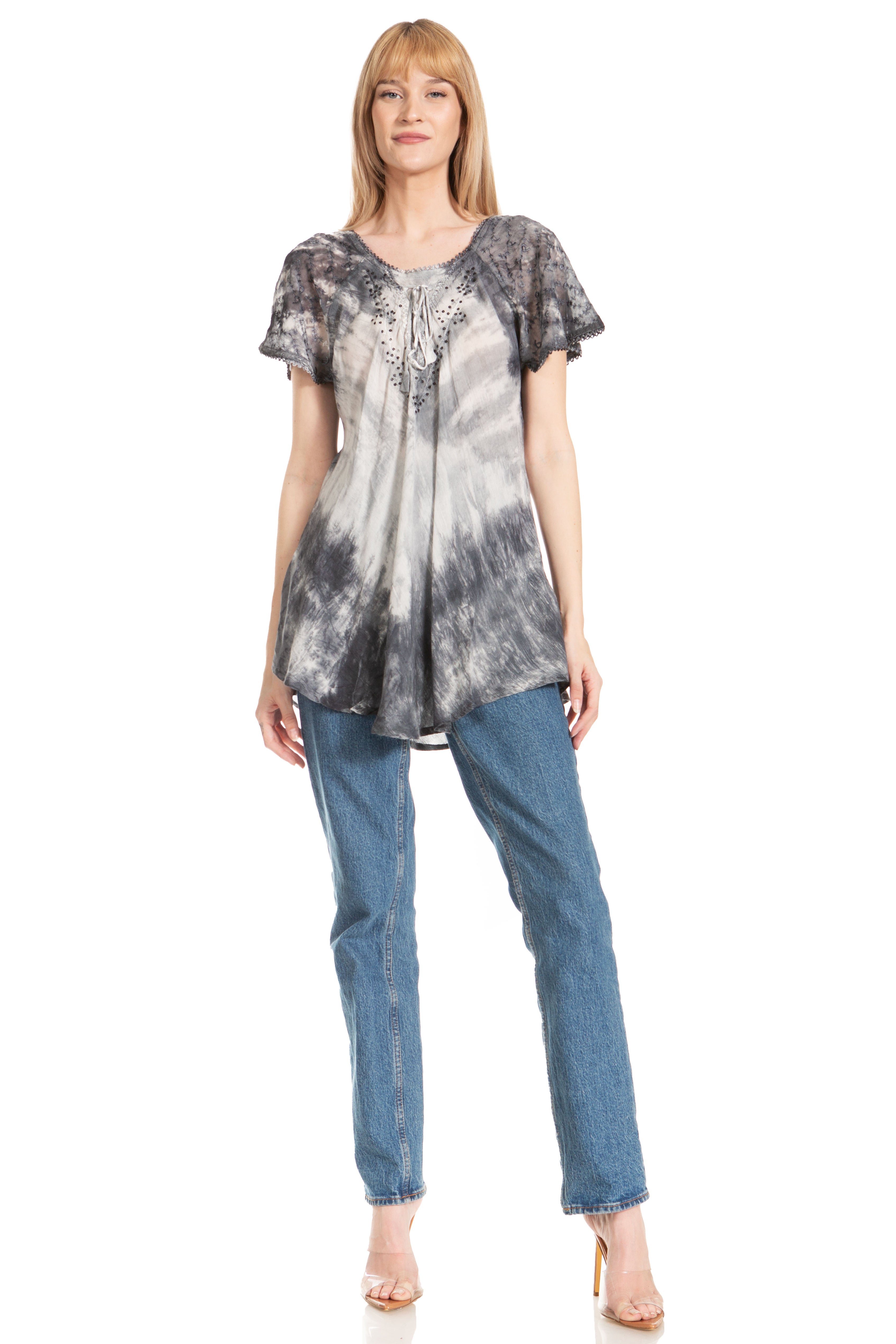 Woman wearing a tie-dye shirt and blue jeans on a white background