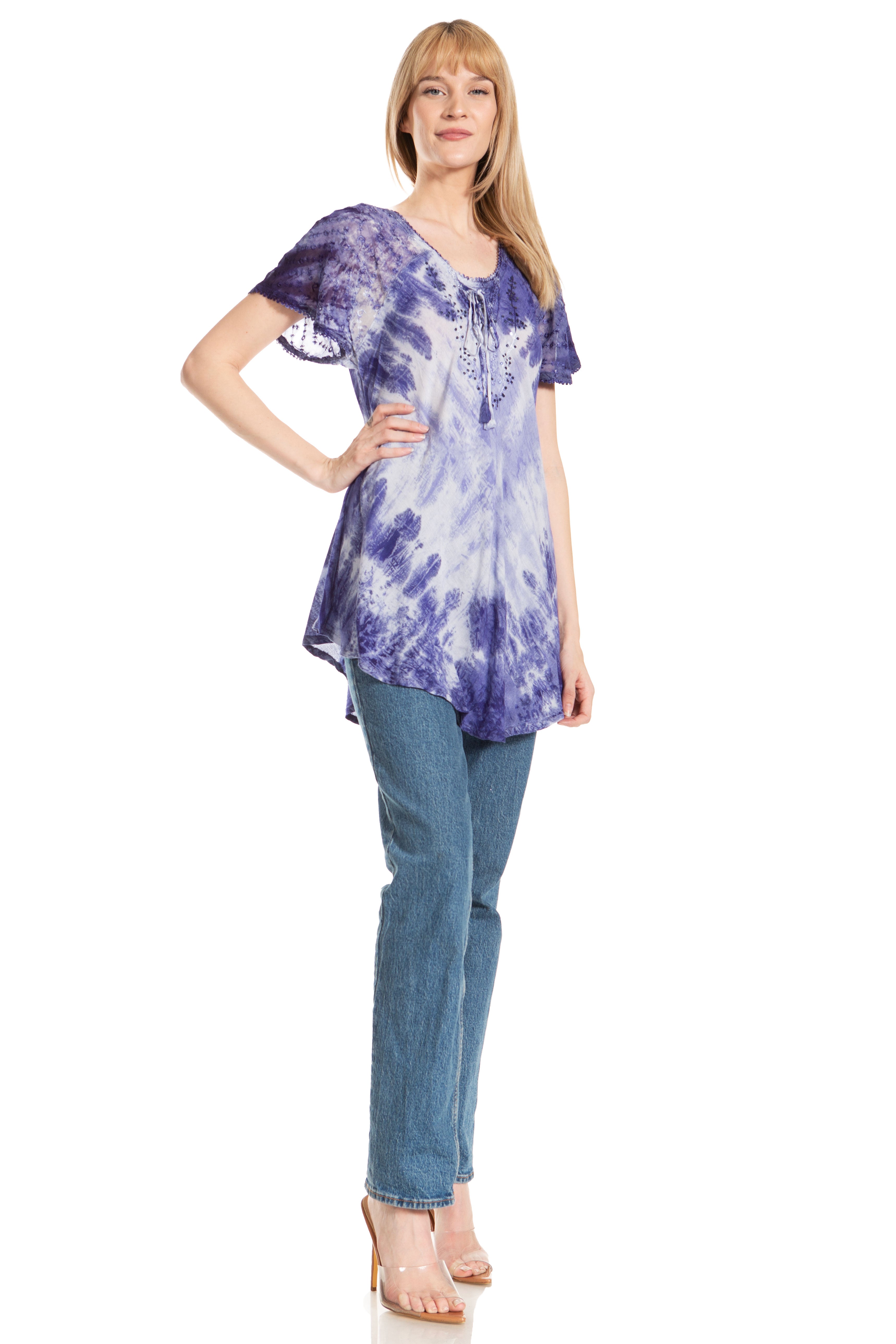 Woman wearing a purple tie-dye shirt and blue jeans on a white background