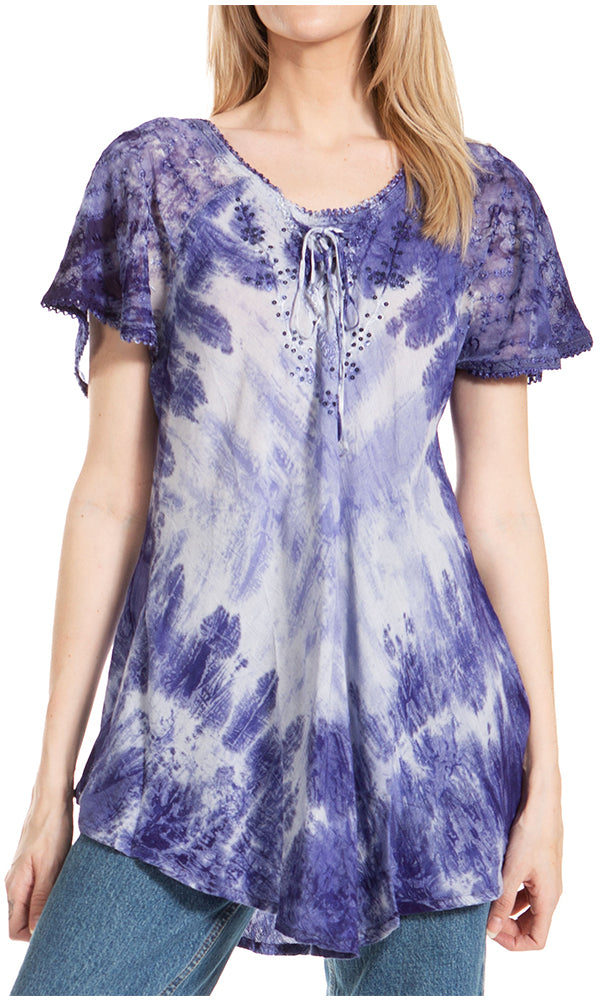 Woman wearing a purple and white tie-dye blouse with short sleeves.