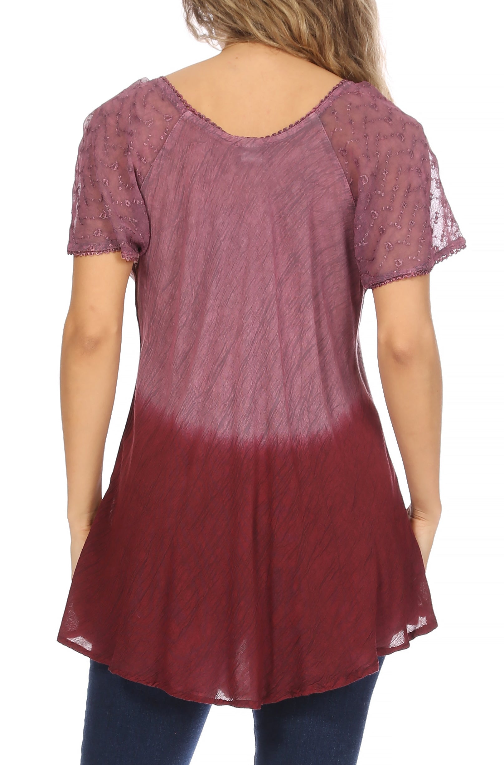 Woman wearing a maroon and pink gradient dress with lace sleeves on a white background