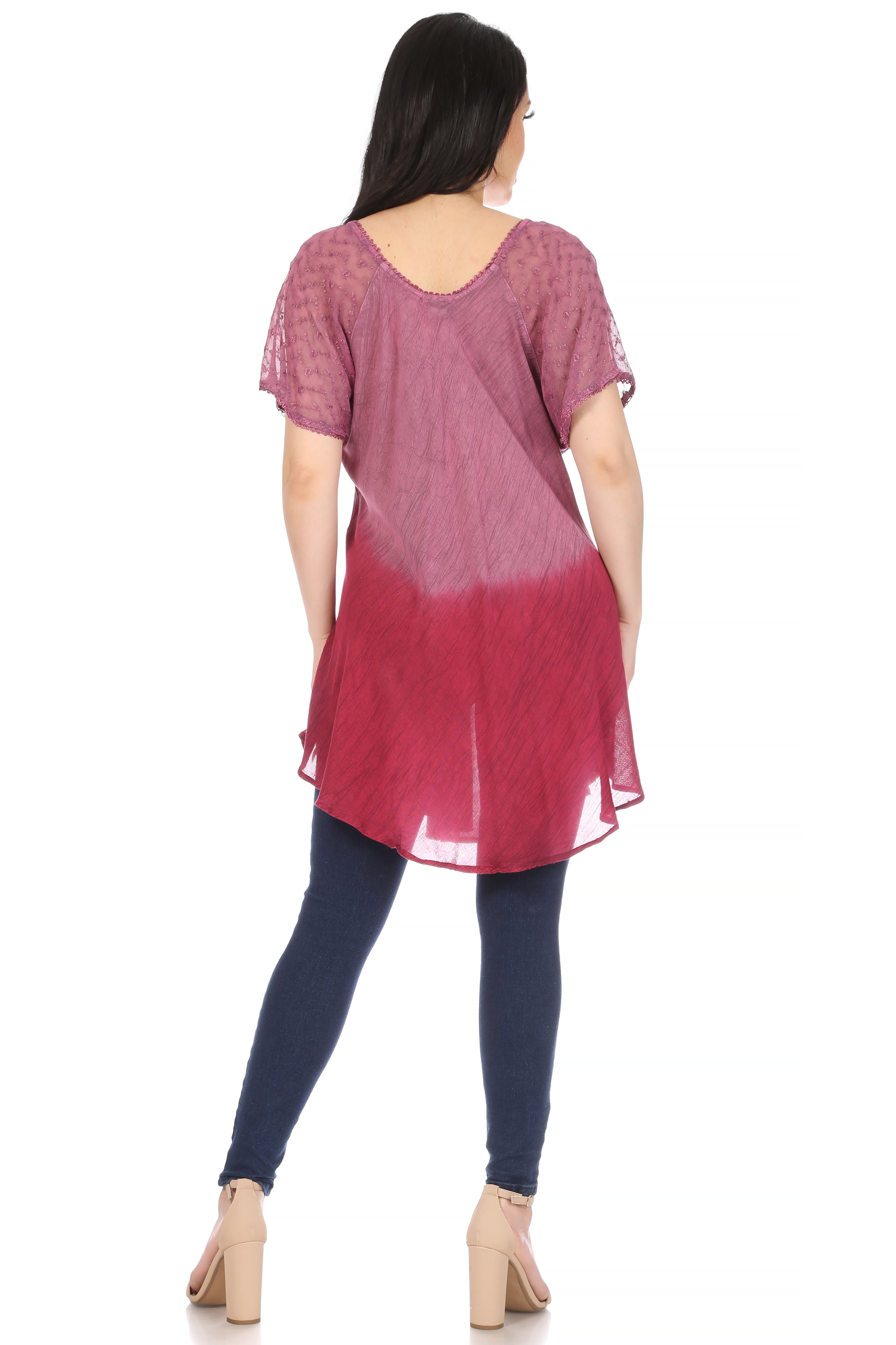 Woman wearing a pink and red gradient dress with blue leggings on a white background