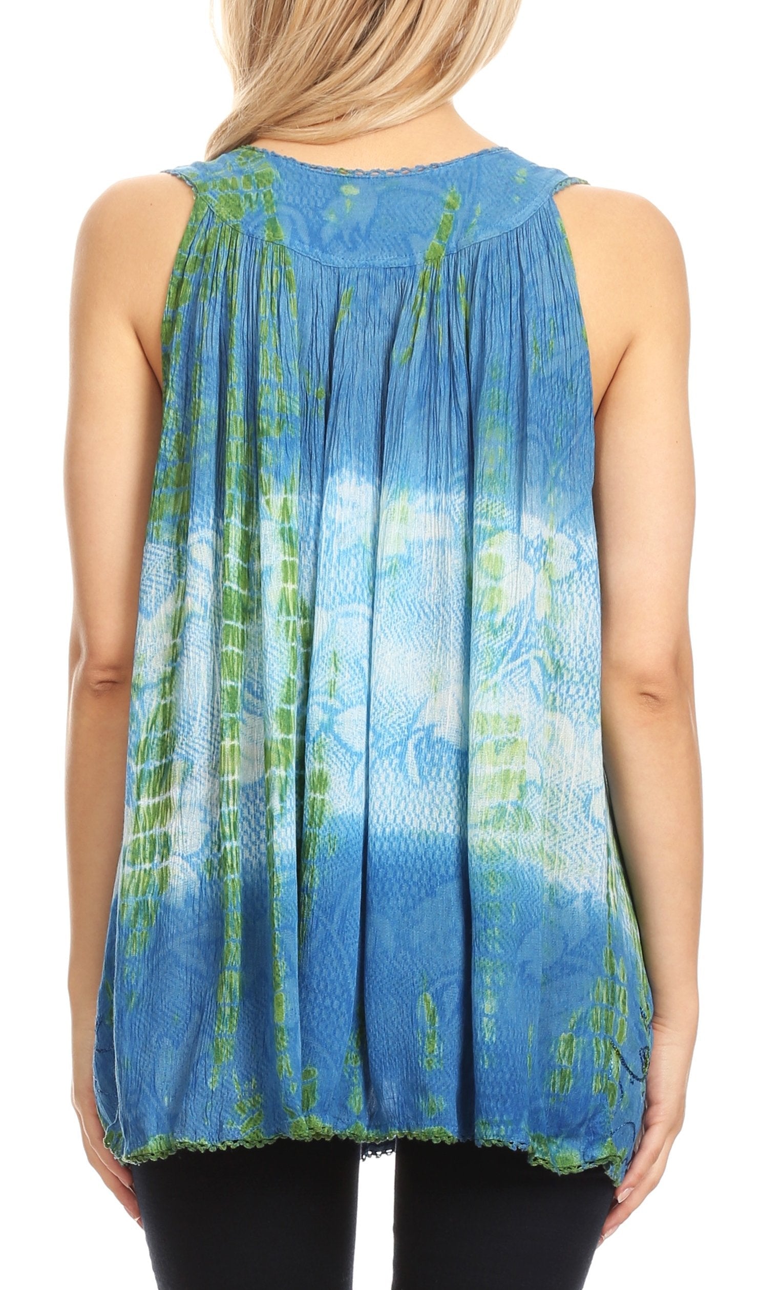 Woman wearing a sleeveless blue and green patterned top on a white background