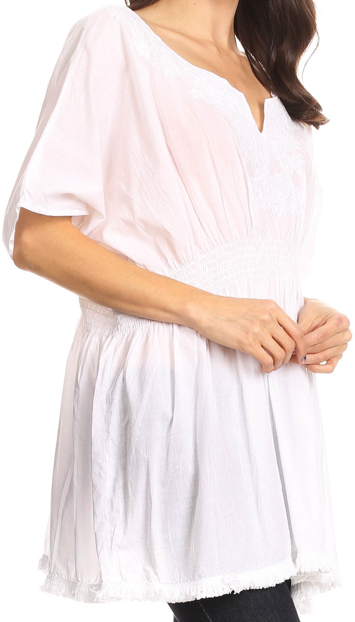 White tunic worn by a person on a white background