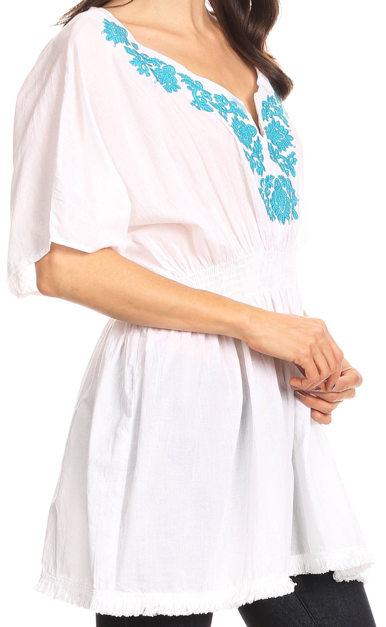 White dress with blue embroidery on a white background
