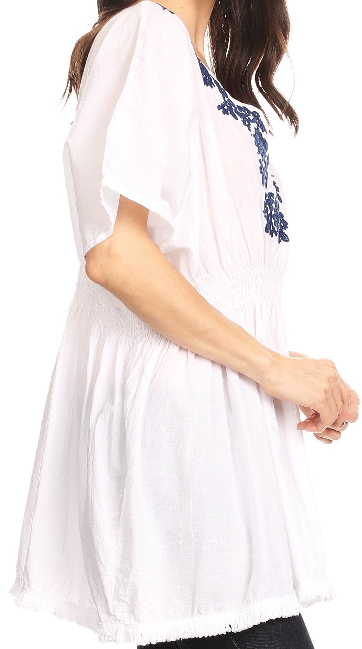 White dress with blue floral embroidery on a white background