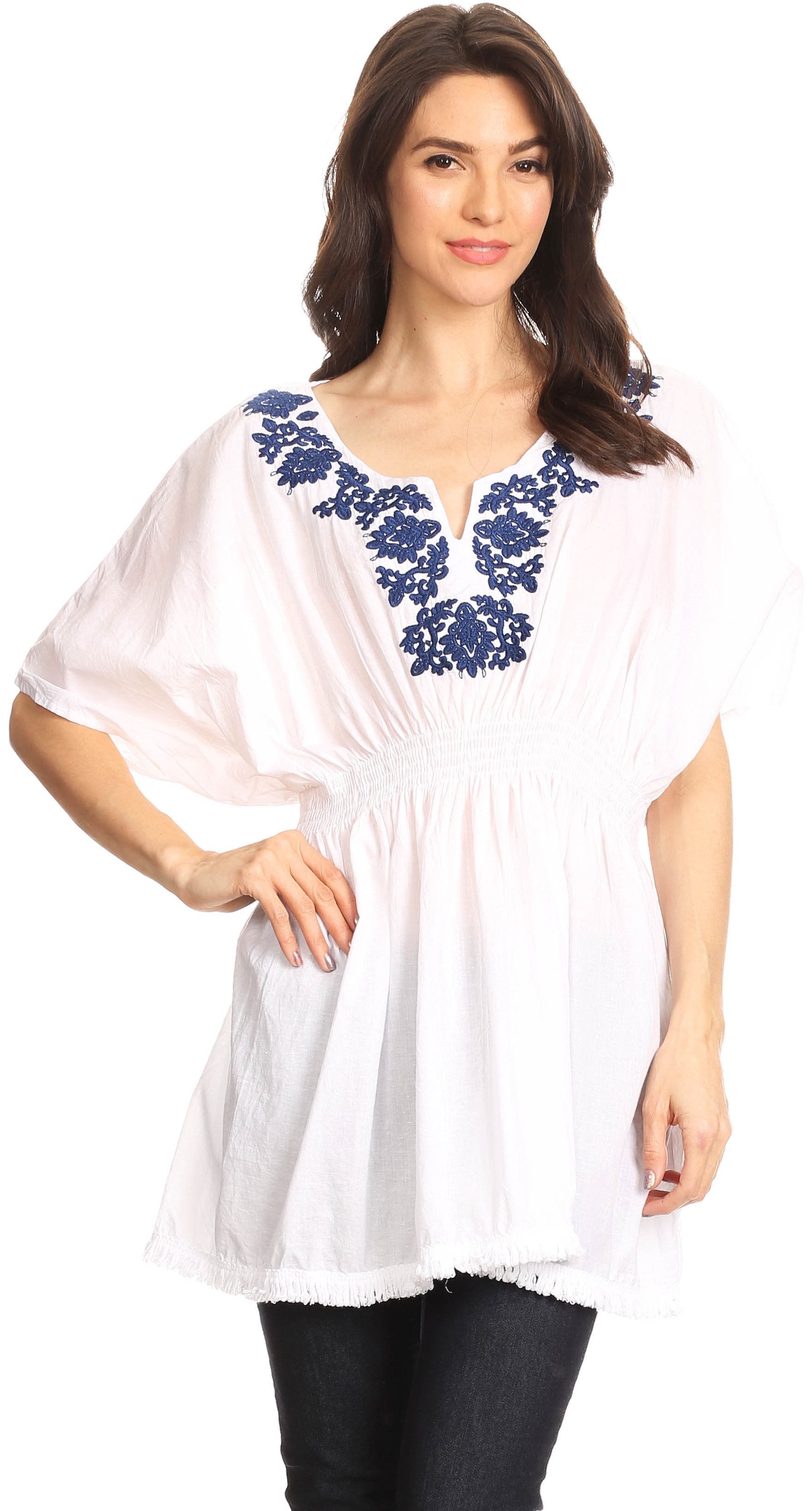 Woman wearing a white blouse with blue embroidery on a white background