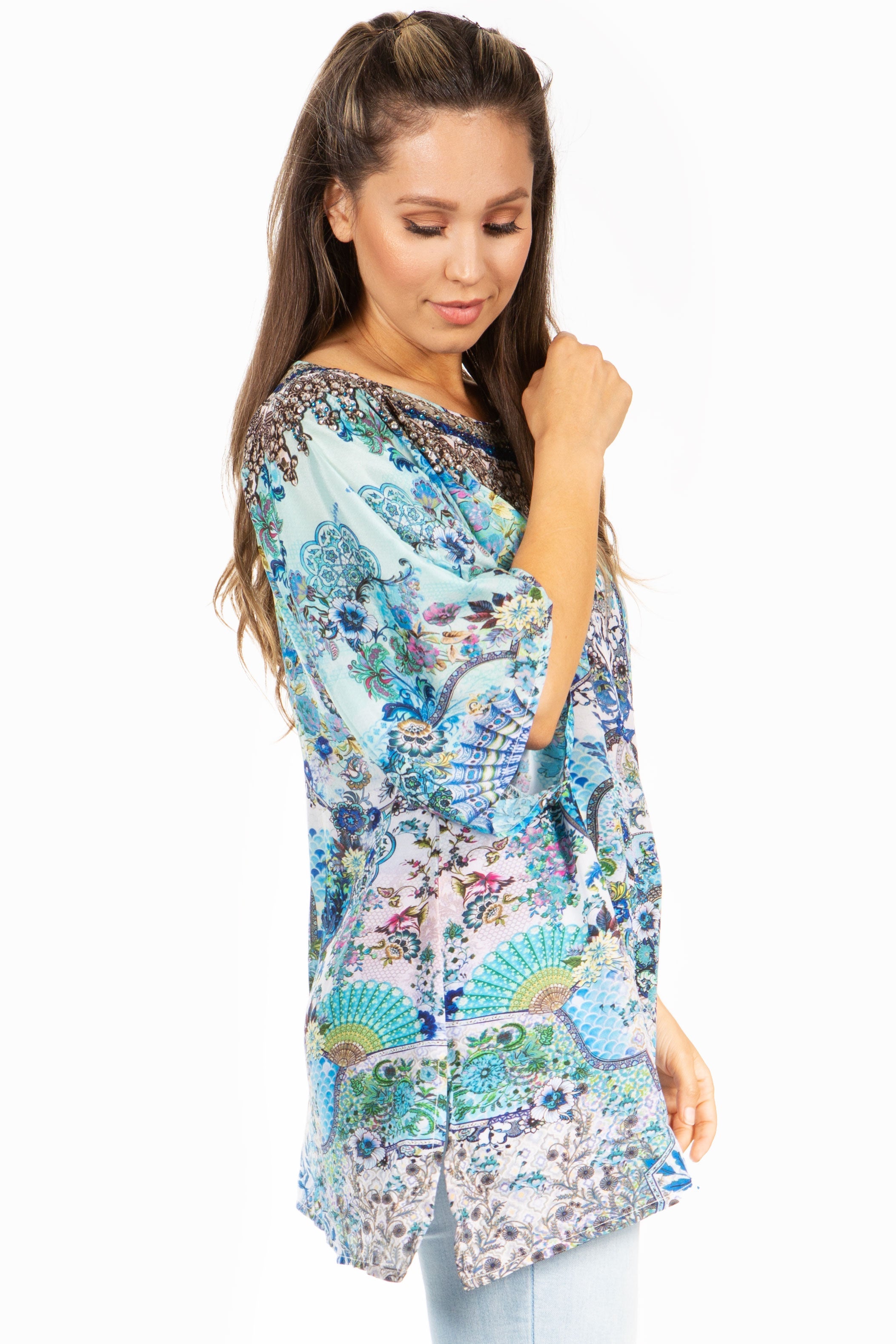 Woman wearing a colorful patterned dress on a white background