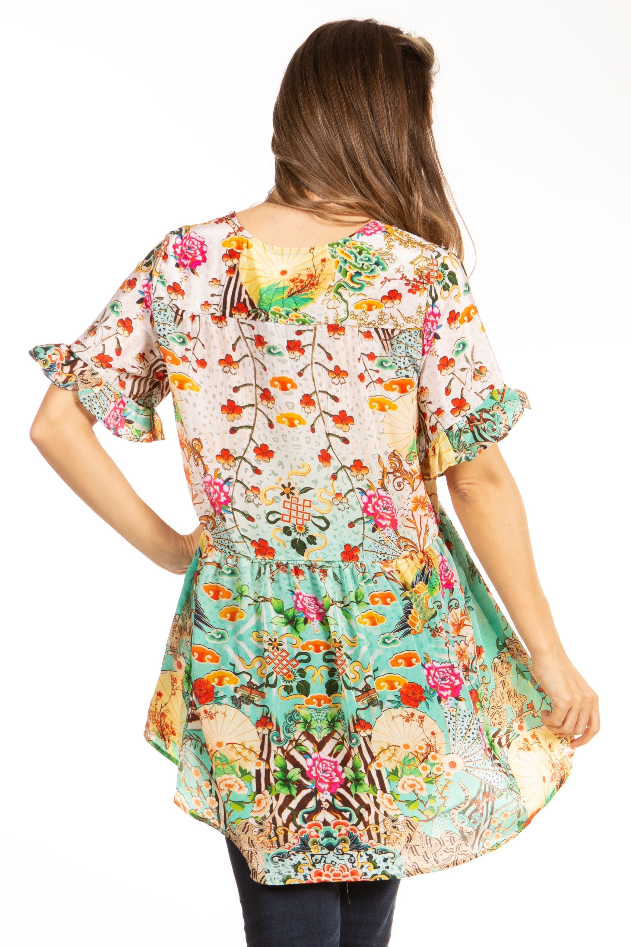 Woman wearing a colorful floral dress on a white background