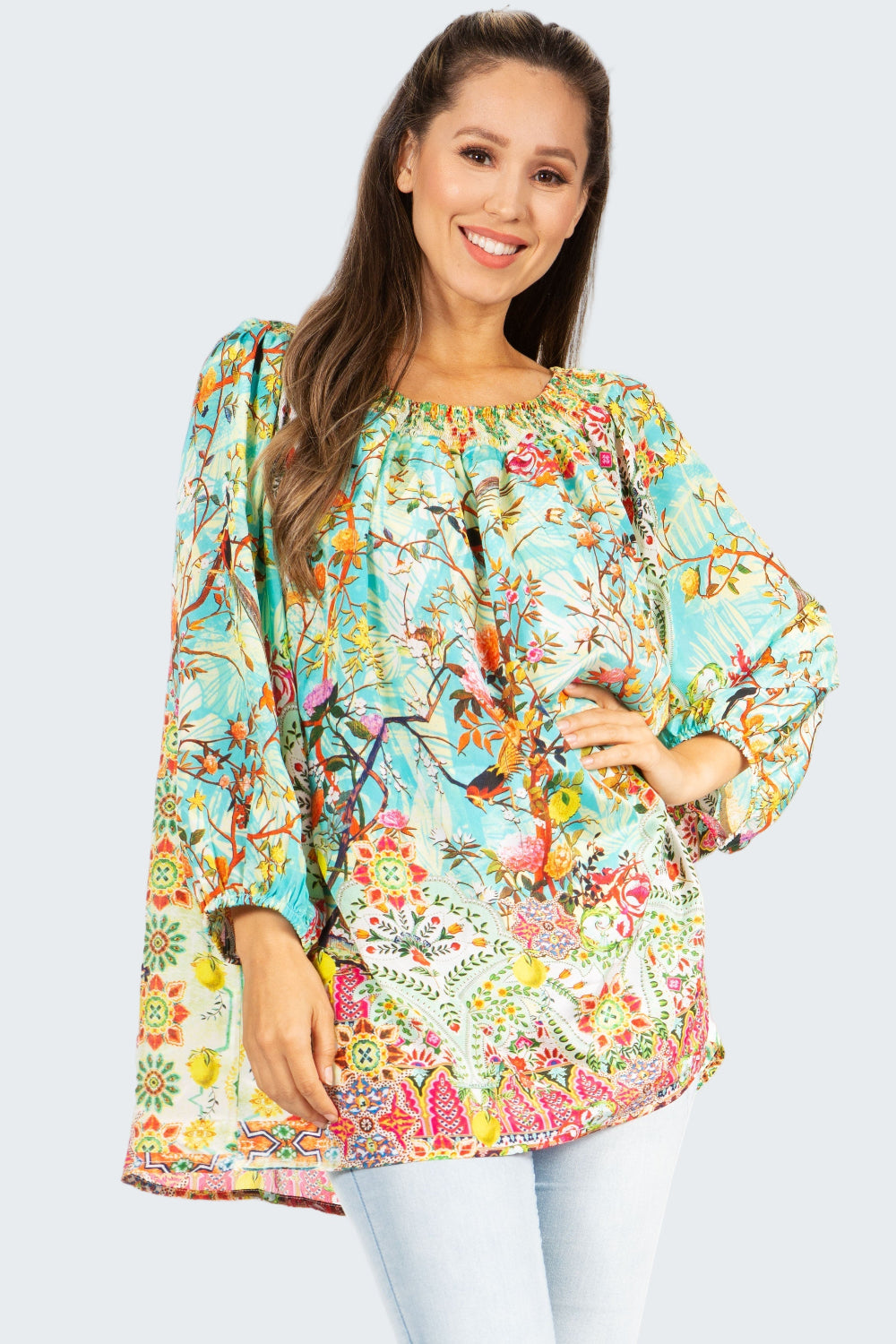 Woman wearing a colorful floral blouse with a white background