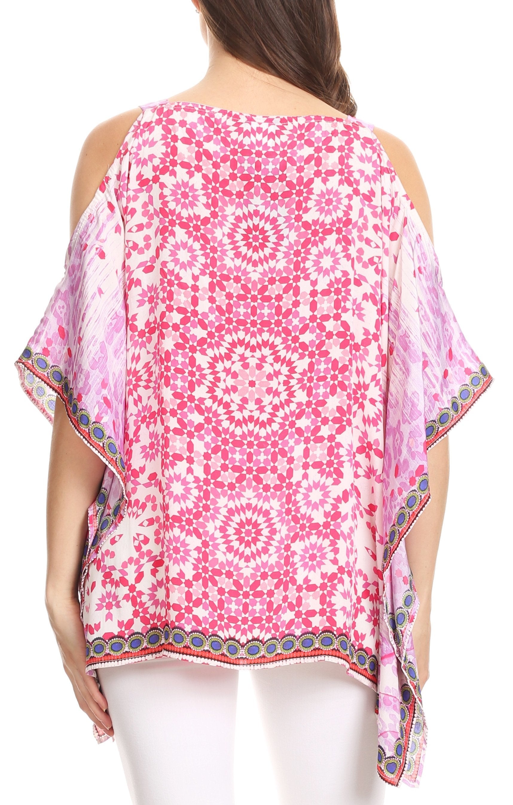 Woman wearing a pink floral patterned top with cold shoulder design on a white background