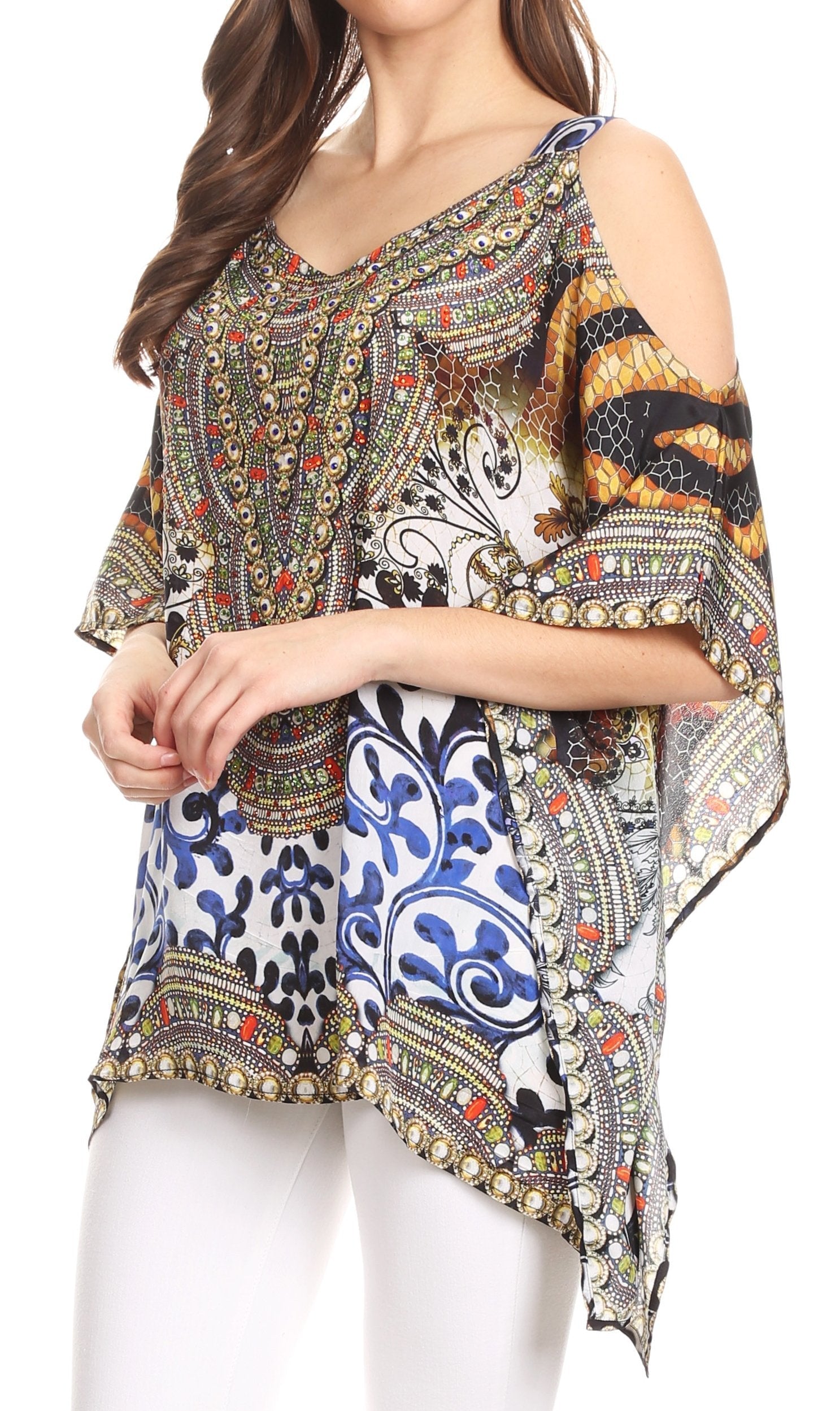 Woman wearing a colorful patterned top with white pants on a white background
