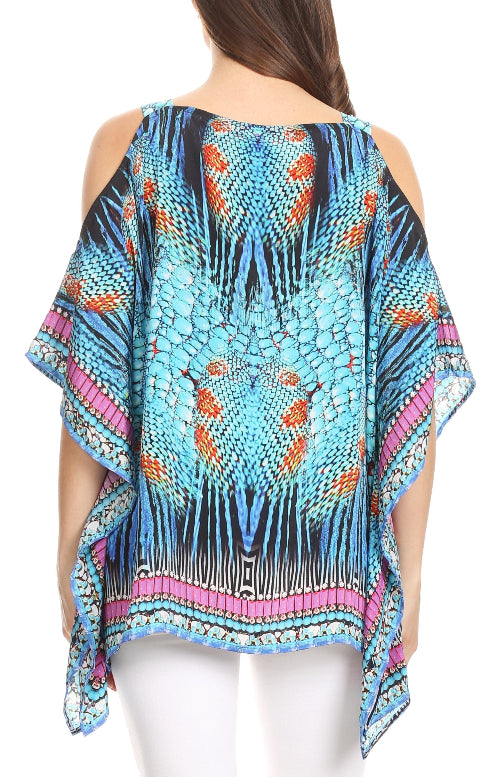 Woman wearing a colorful patterned top with a white background