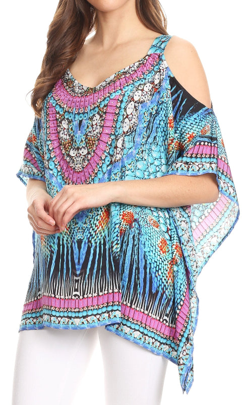 Woman wearing a colorful patterned top with cold shoulder design on a white background