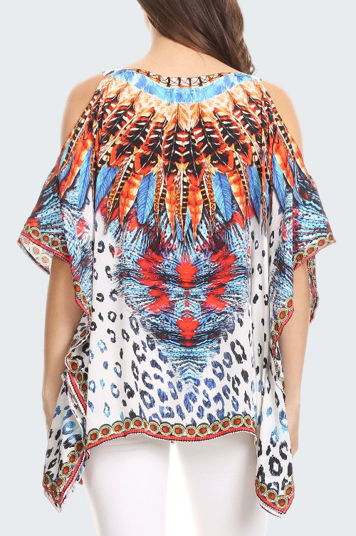 Colorful patterned top worn by a person on a white background