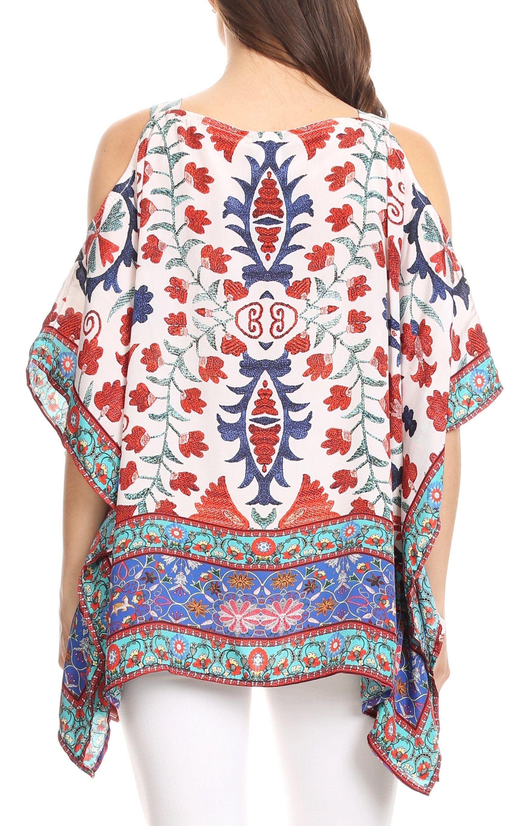 Woman wearing a colorful patterned top with a white background