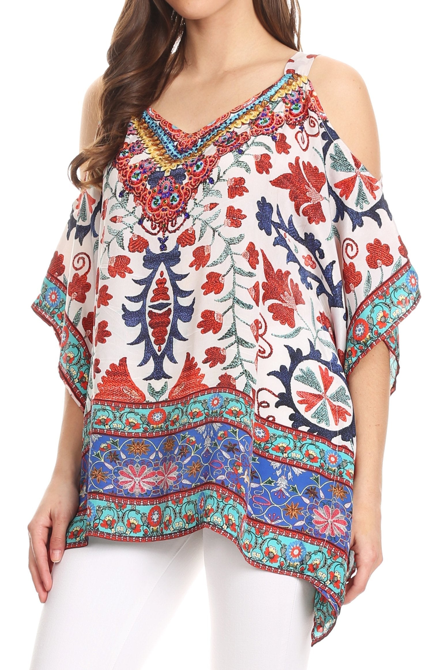 Woman wearing a colorful patterned top with cold shoulder design.