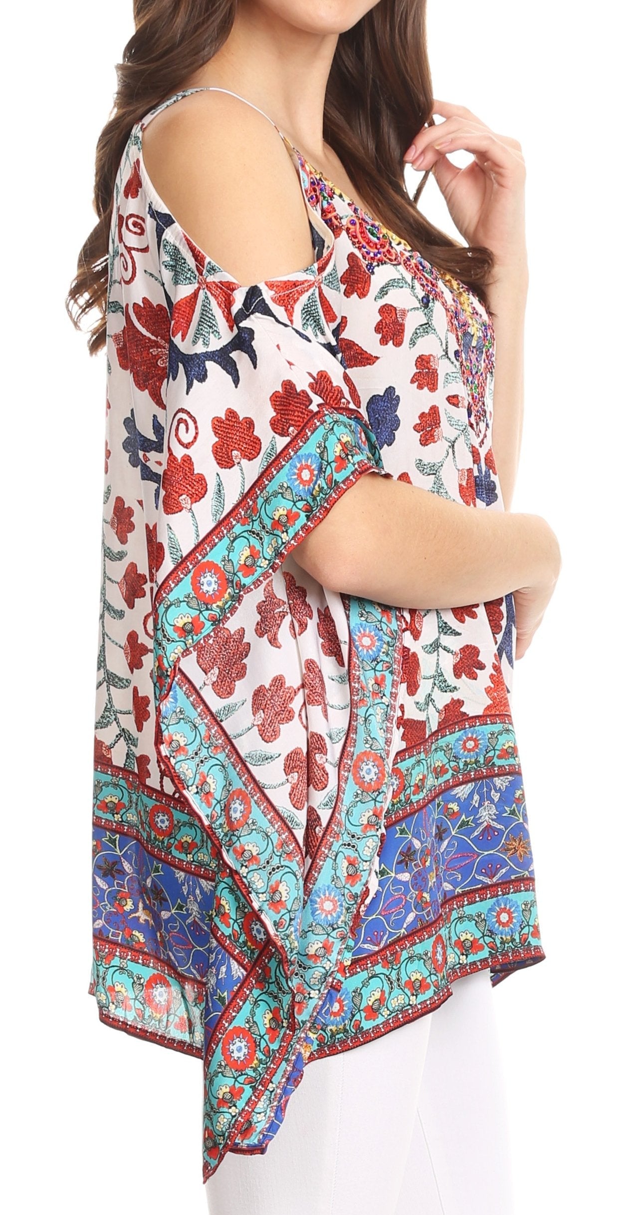 Woman wearing a colorful floral and geometric patterned top on a white background