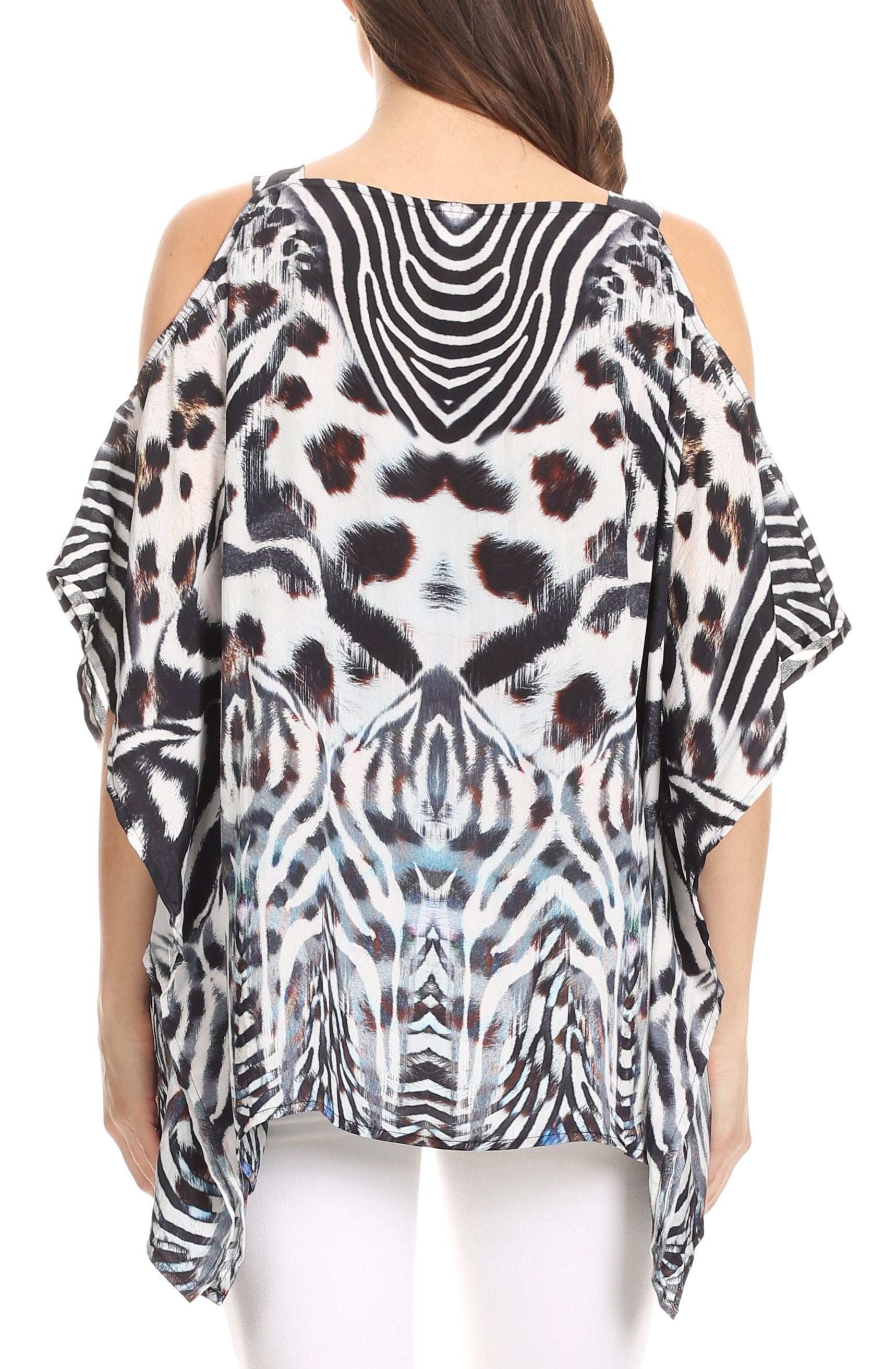 Woman wearing a patterned blouse with zebra and abstract designs on a white background