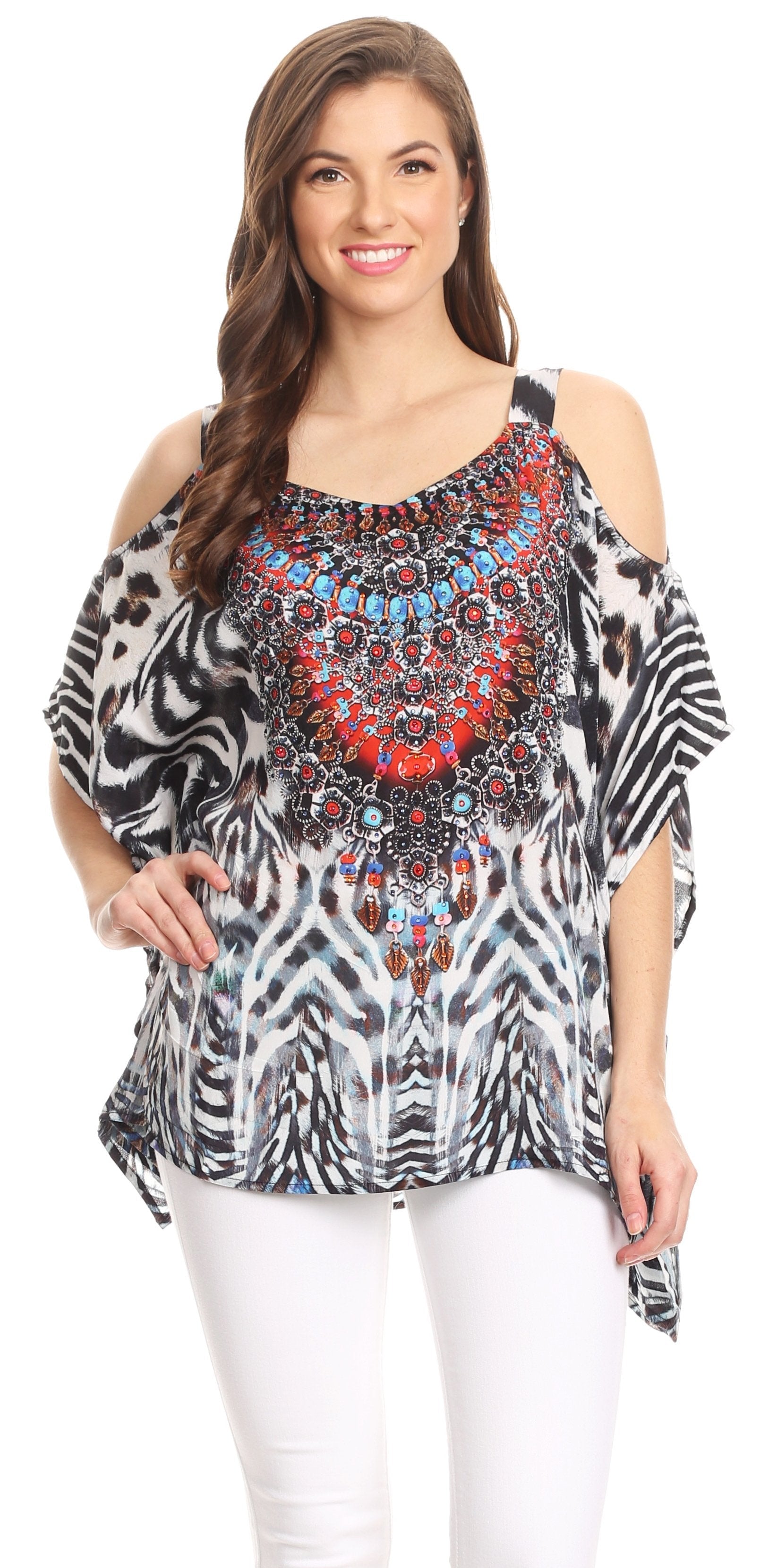 Woman wearing a patterned top with cold shoulder design on a white background