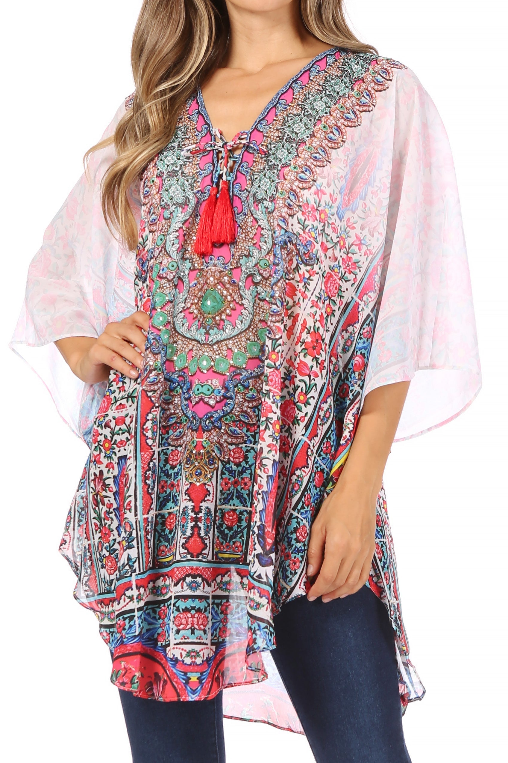 Woman wearing a colorful patterned dress with a tassel detail on a white background