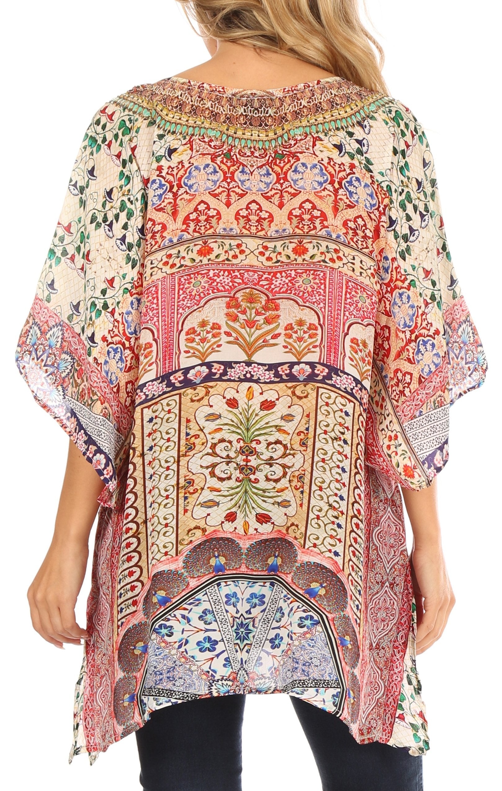 Woman wearing a colorful patterned blouse with a white background