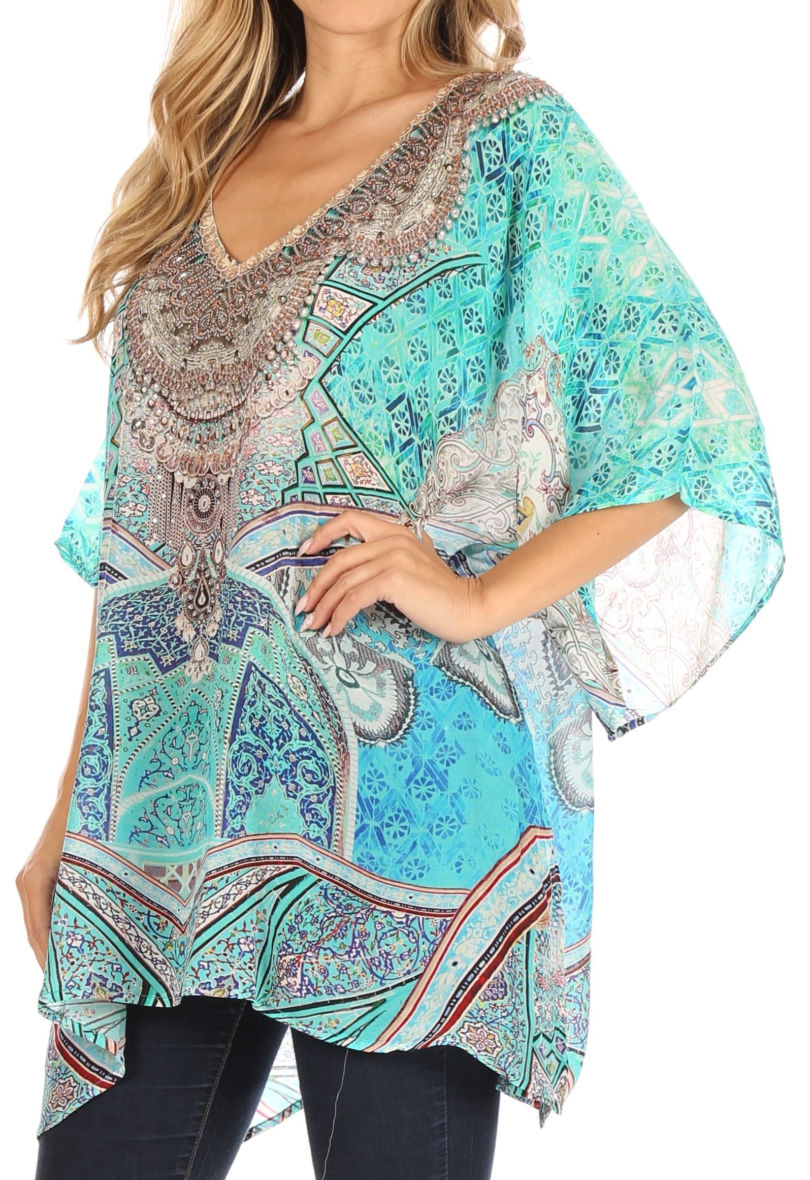 Woman wearing a colorful patterned top with lace sleeves on a white background
