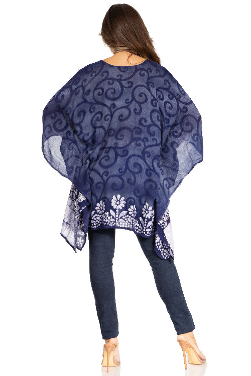 Woman wearing a blue patterned shawl over a white background