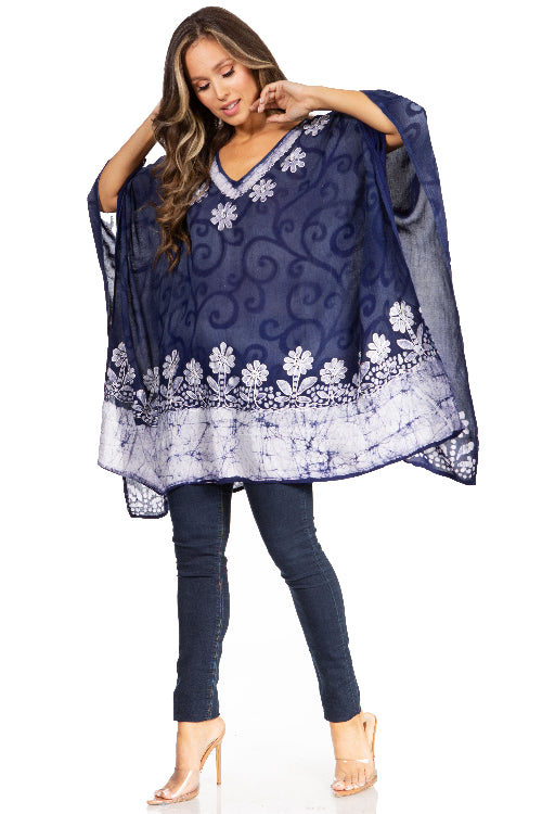 Woman wearing a navy blue floral patterned top and jeans on a white background