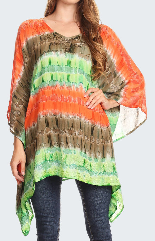 Woman wearing a colorful tie-dye poncho with orange, green, and brown patterns.