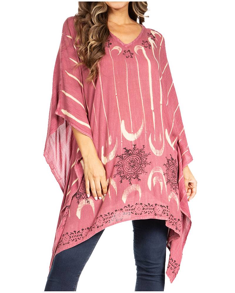 Pink poncho with white elephant design worn by a person on a white background