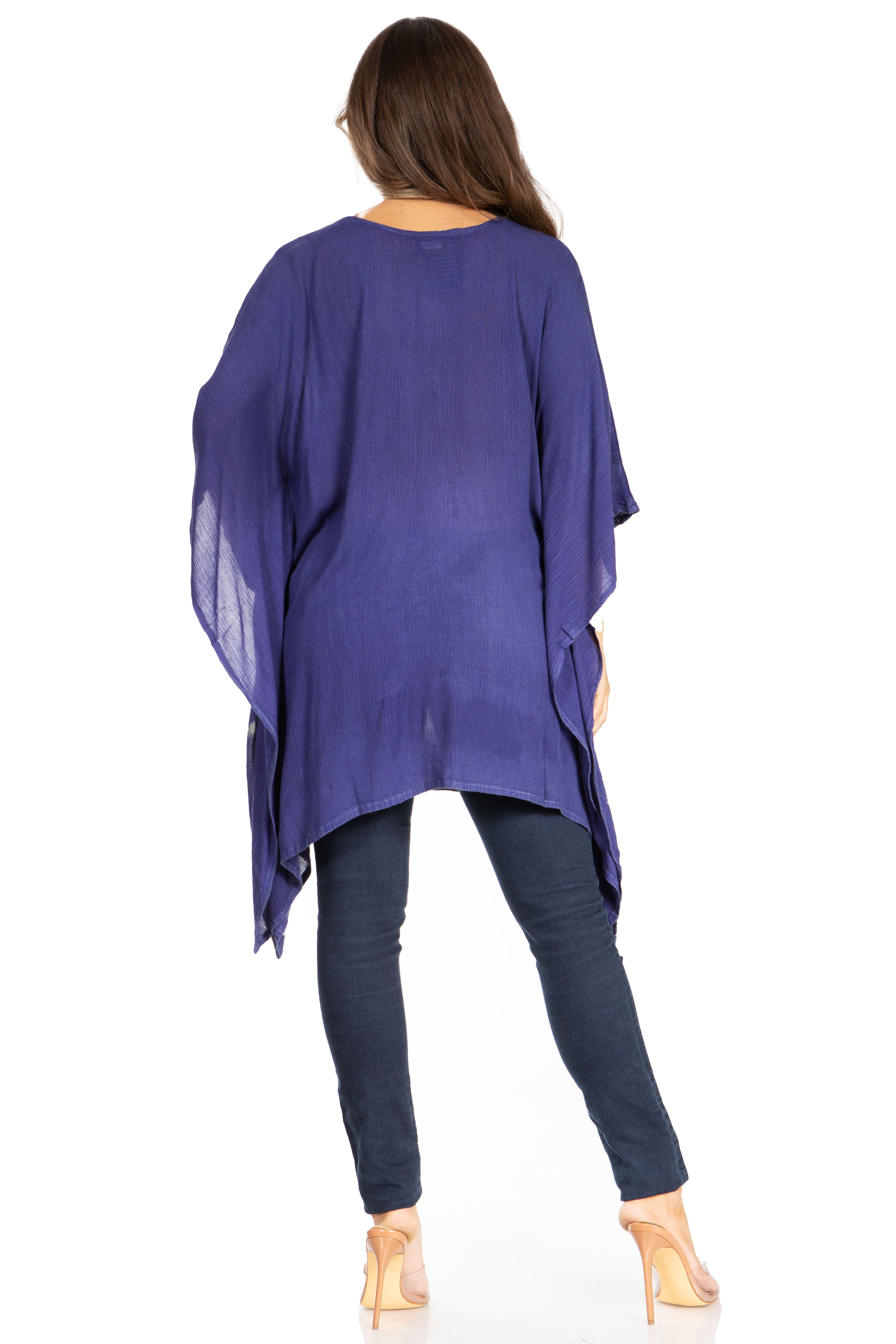 Woman wearing a long, dark blue kimono-style garment on a white background