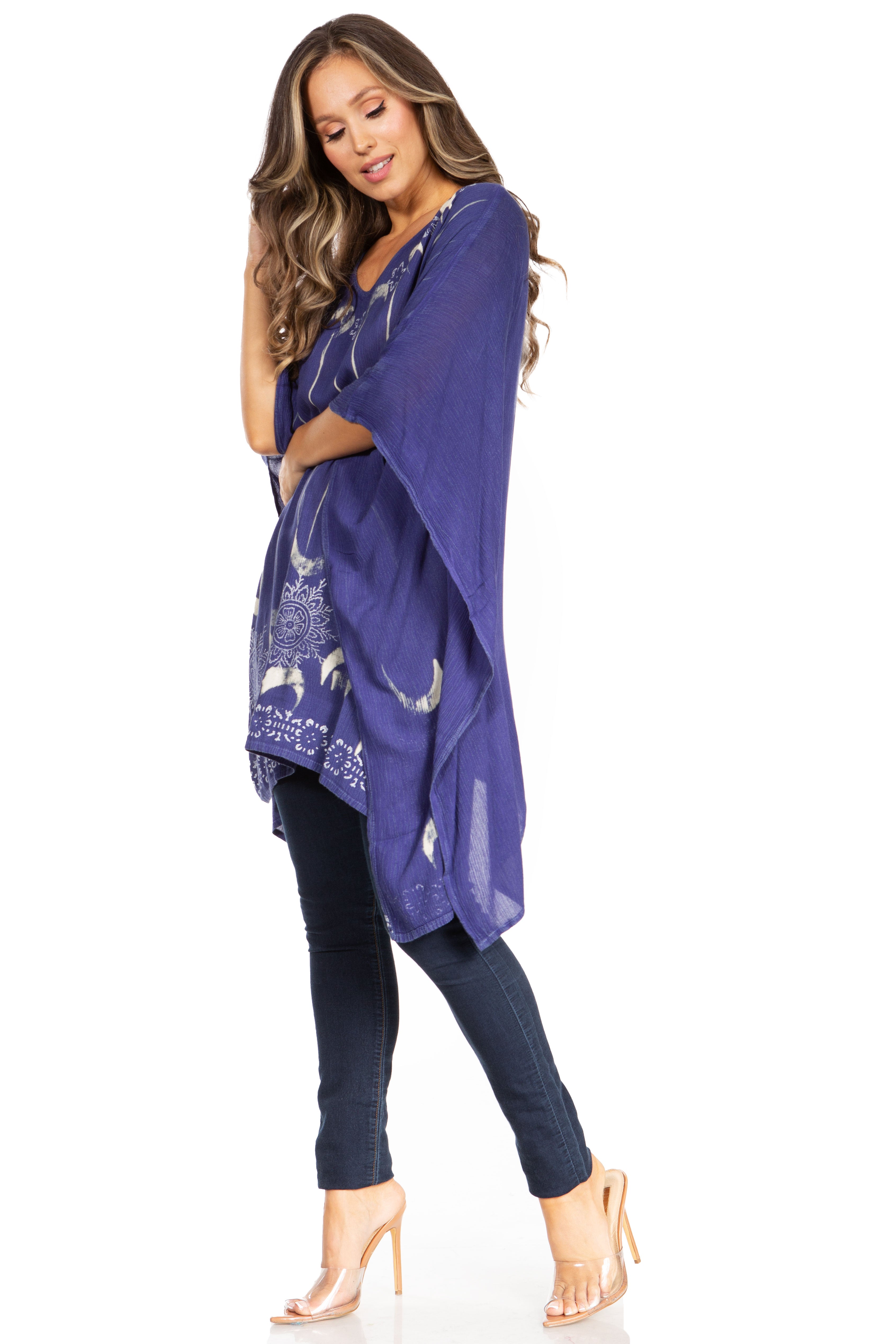 Woman wearing a long purple scarf with white patterns on a white background
