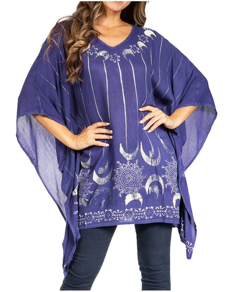 Woman wearing a purple poncho with white moon and star patterns on a white background