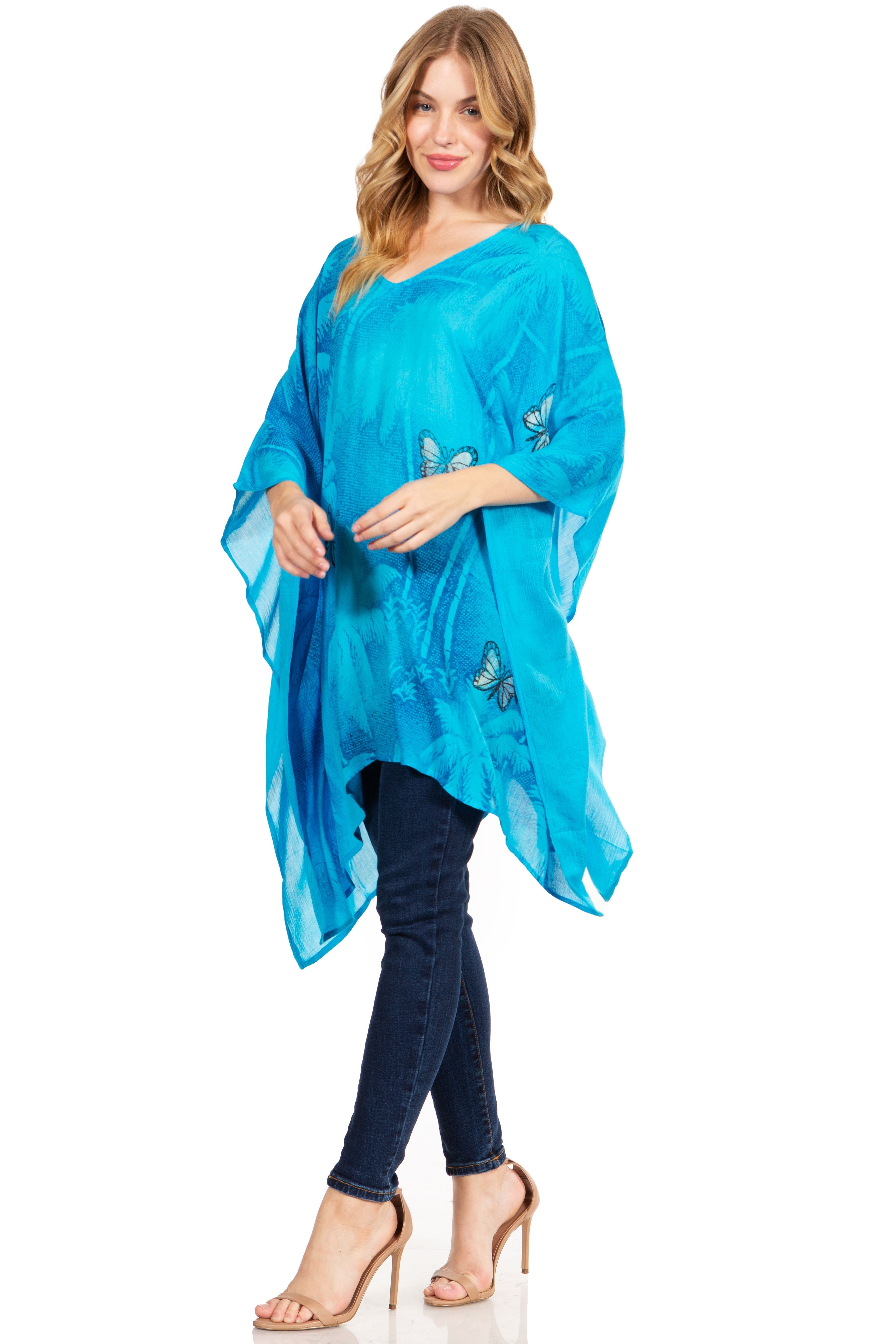 Woman wearing a blue scarf with butterfly designs on a white background