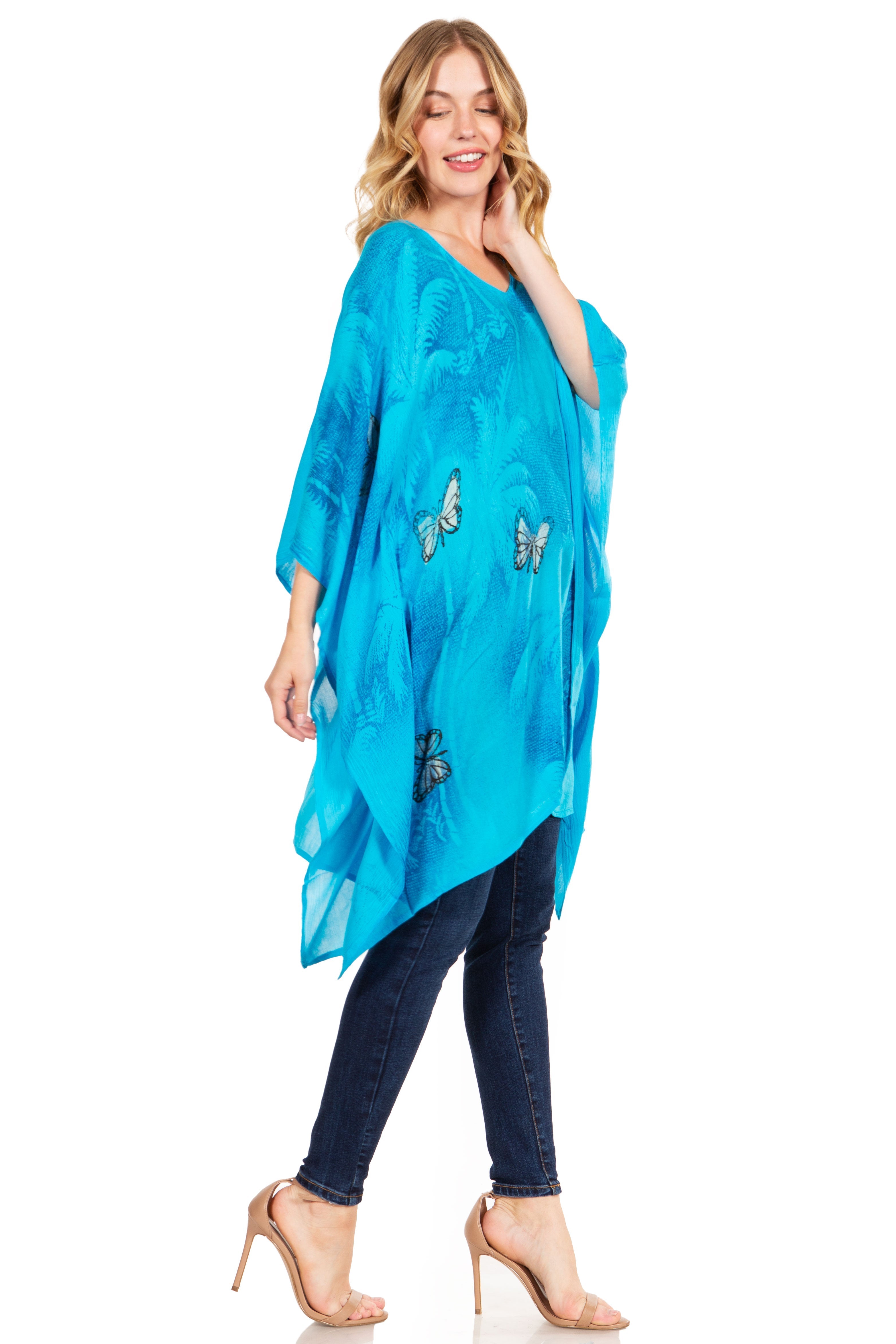 Woman wearing a blue scarf with butterfly designs on a white background