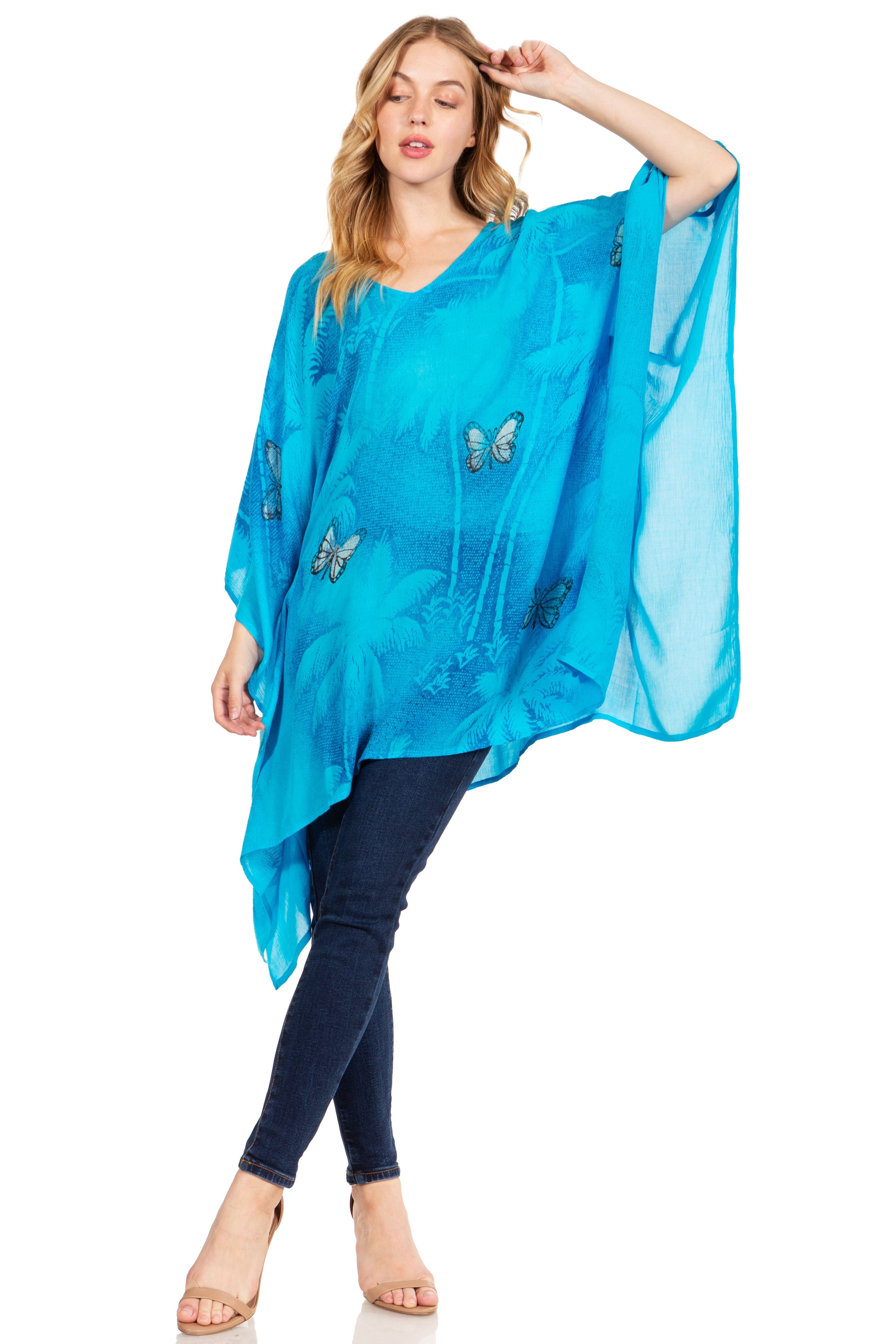 Woman wearing a blue sheer top with butterfly designs on a white background