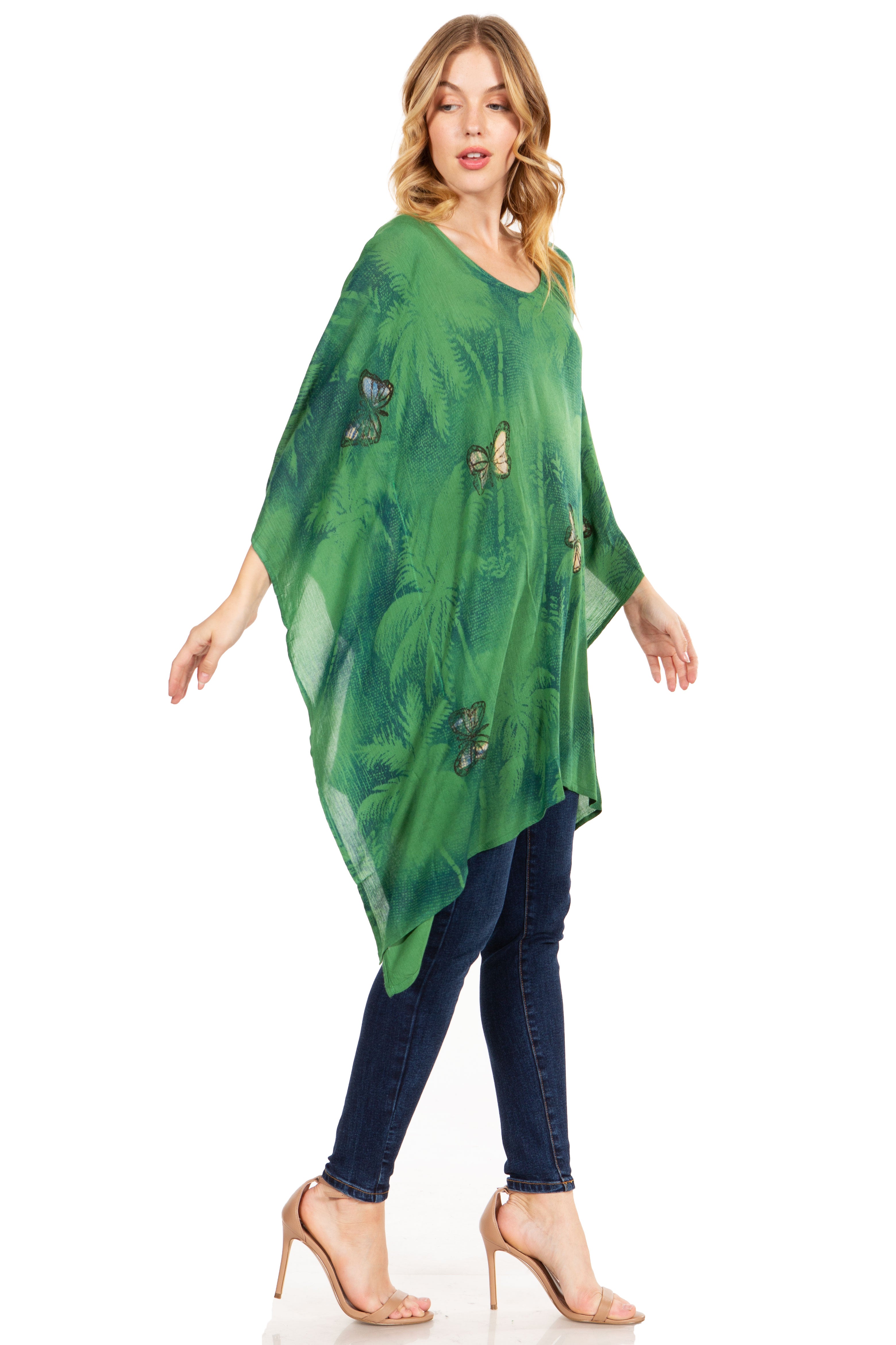 Woman wearing a green leaf-patterned poncho on a white background