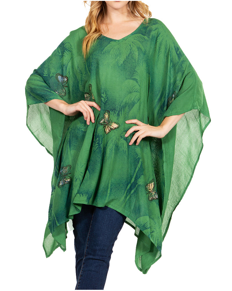 Green poncho with butterfly patterns worn by a person on a white background