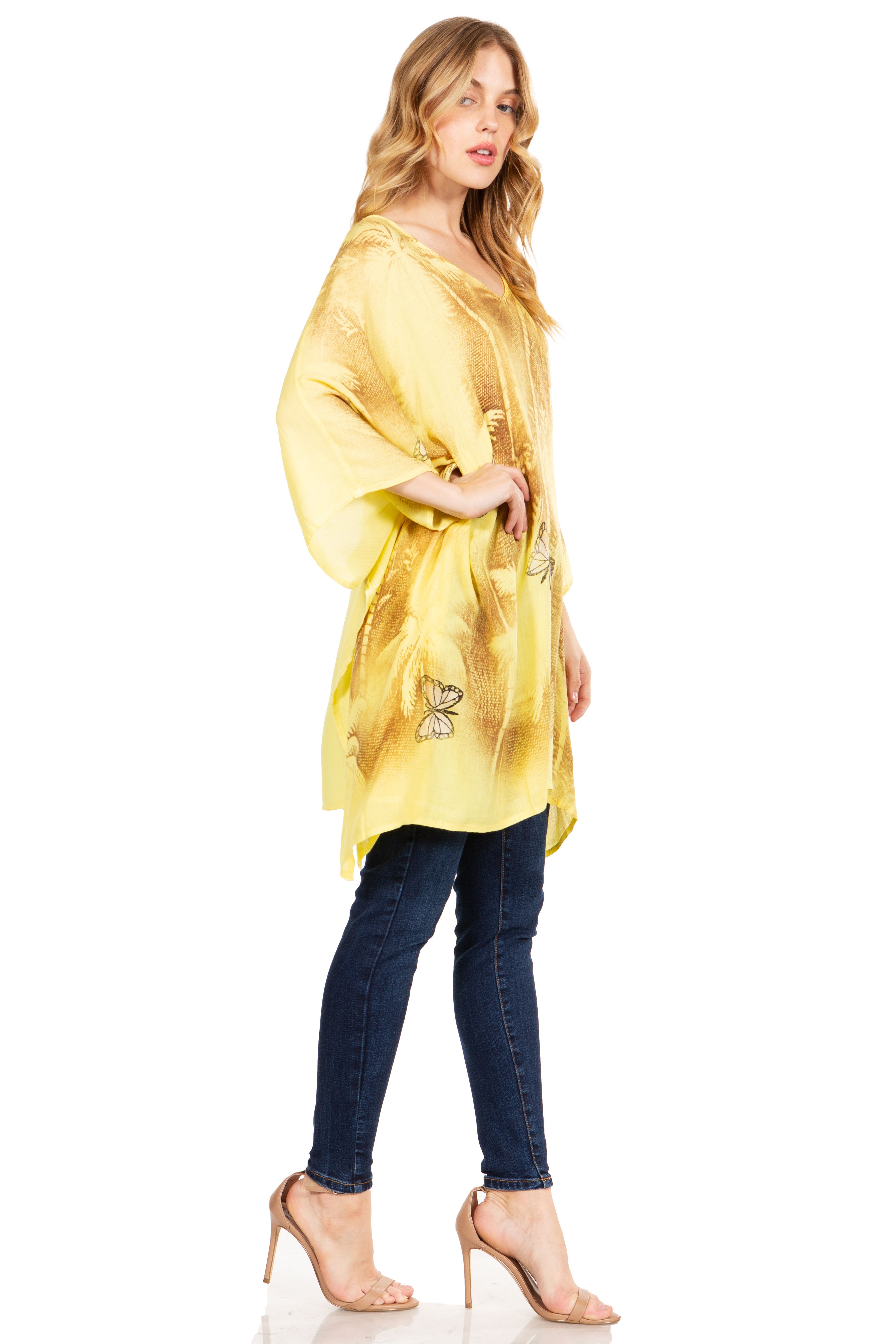 Woman wearing a yellow kimono-style garment over a dark outfit on a white background