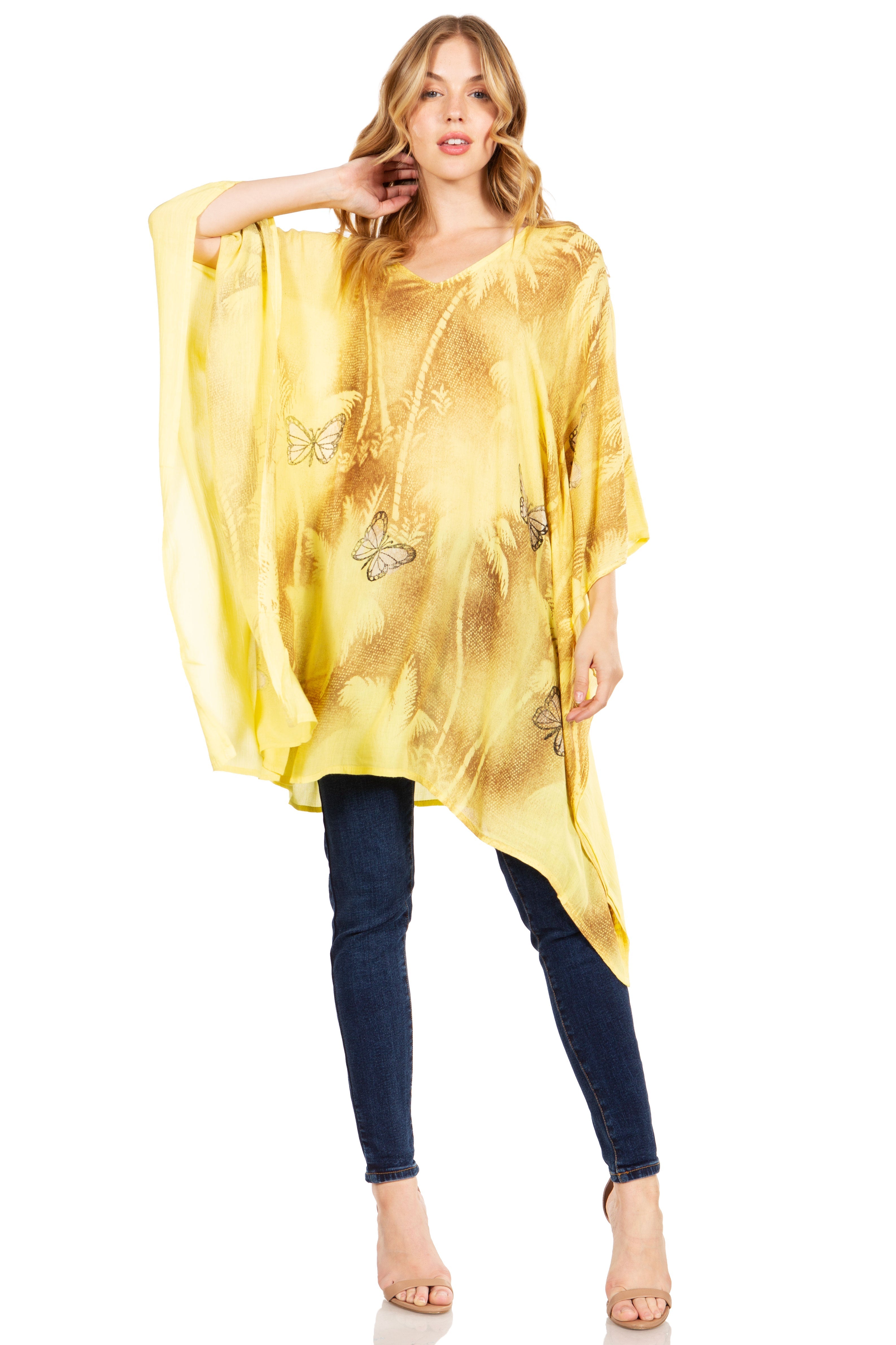 Woman wearing a yellow tie-dye cover-up with butterfly designs on a white background